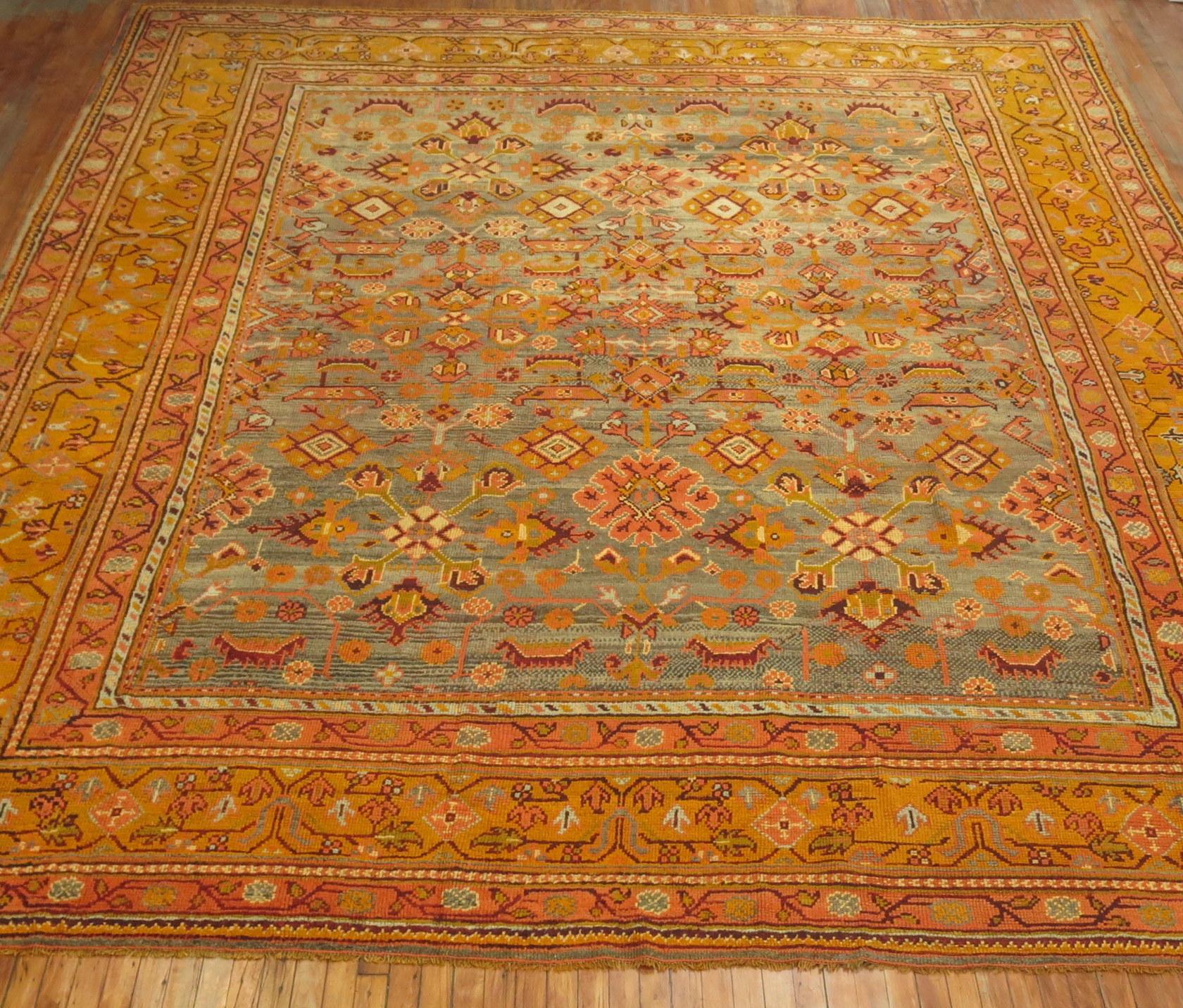 An early 20th century square size antique Turkish Oushak featuring an-all over design in bright saturated colors.

Oushak rugs originated in the small town of Oushak in west-central Anatolia, today just south of Istanbul, Turkey. Unlike most