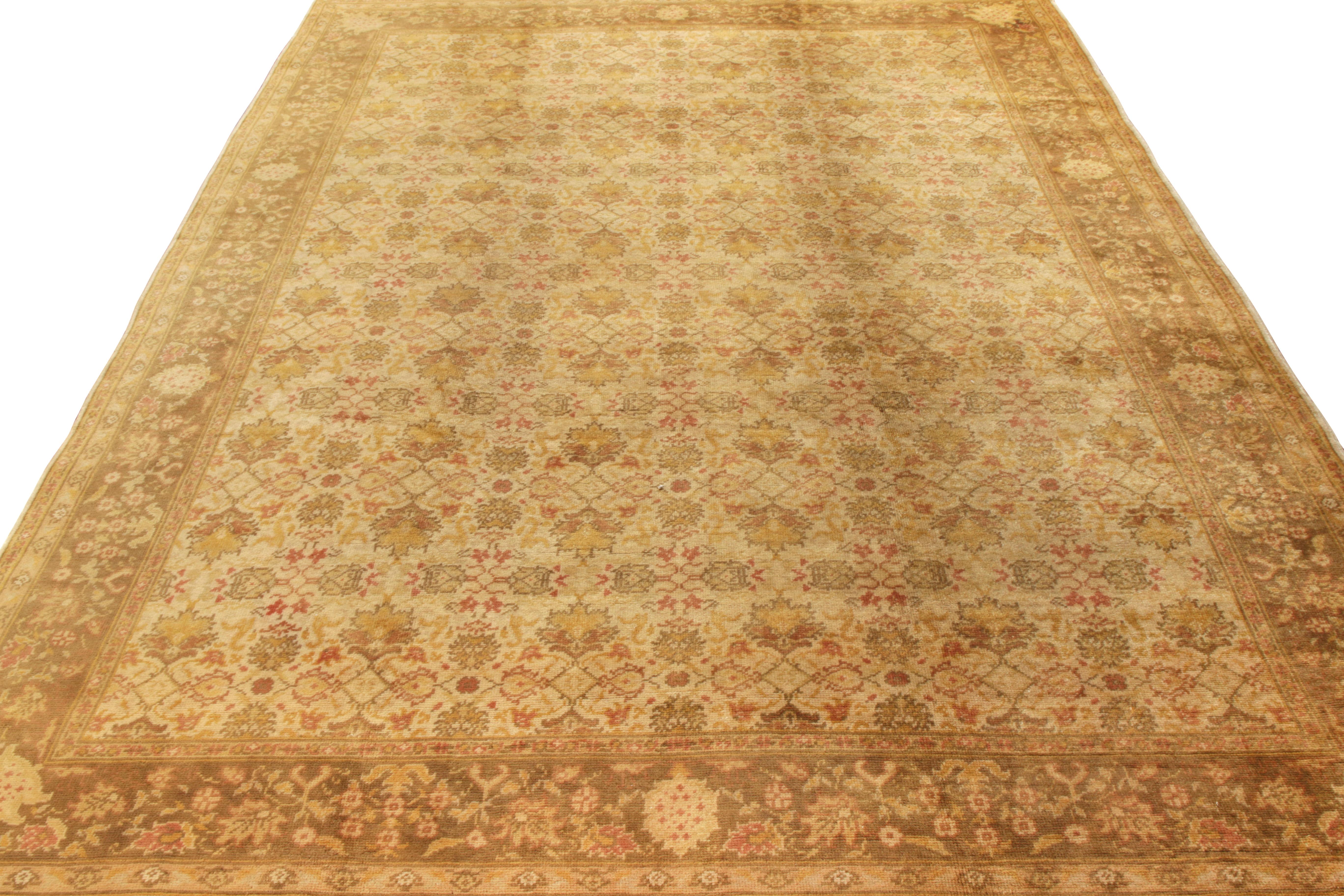 Hand-knotted in wool circa 1950-1960, this 9×13 vintage European rug is a rare mid-century Irish take on Turkish Oushak rugs.

On the Design:

Gold tones underscore an all over floral pattern with beige-brown and light red accents—the latter