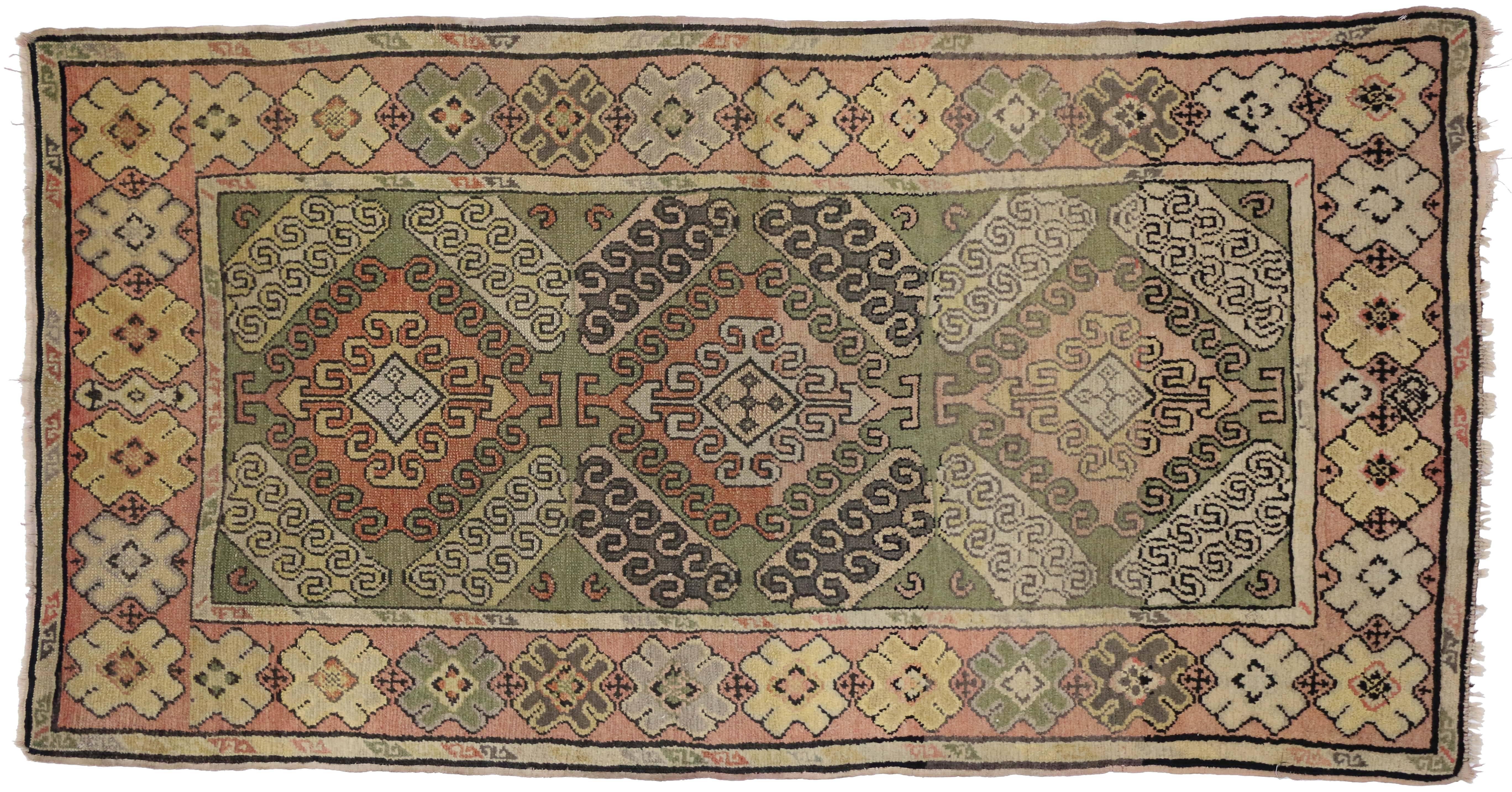 73965, antique Turkish Oushak rug in a classic amulet design. This hand-knotted wool antique Oushak rug features triple amulets centered with diamond patterns that represent the 