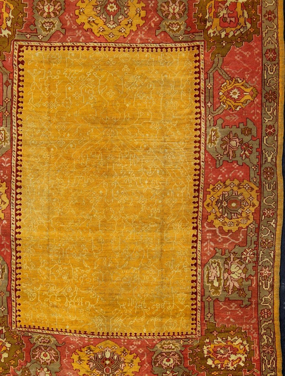 Hand-Knotted Antique Turkish Oushak rug in gold background, Rose Border & Green  For Sale