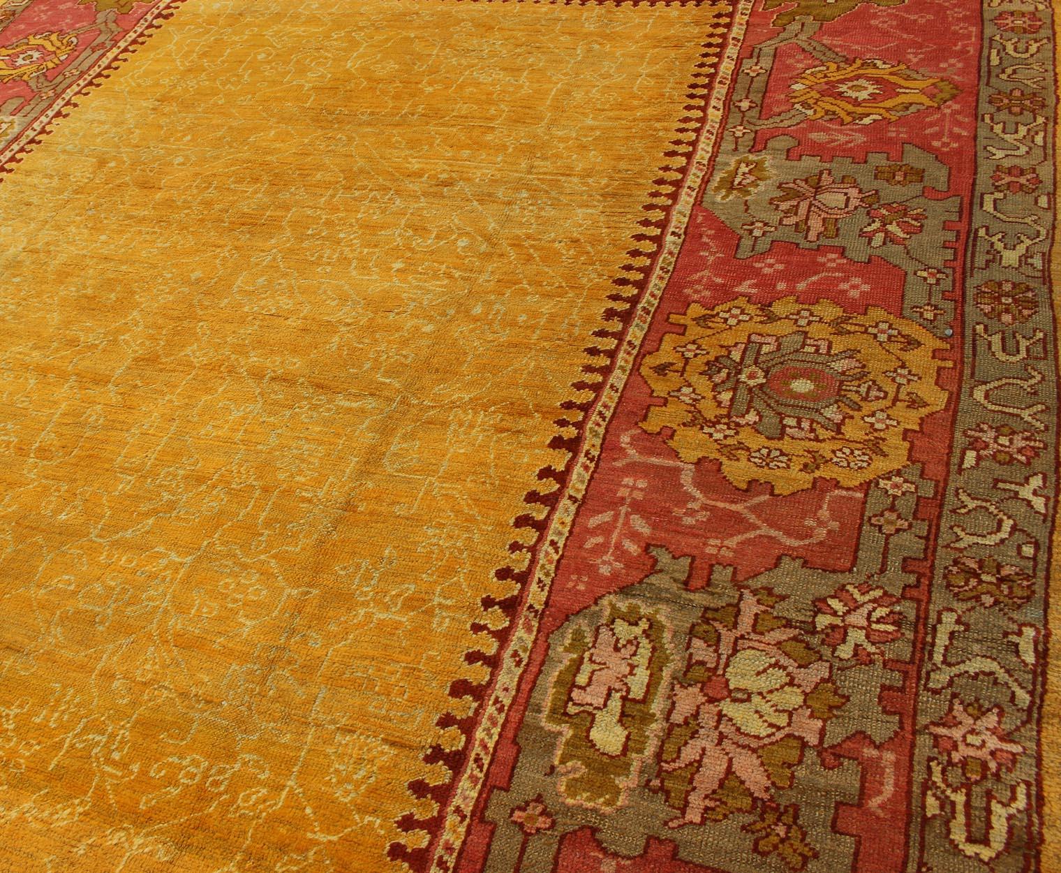 Antique Turkish Oushak rug in gold background, Rose Border & Green  In Excellent Condition For Sale In Atlanta, GA