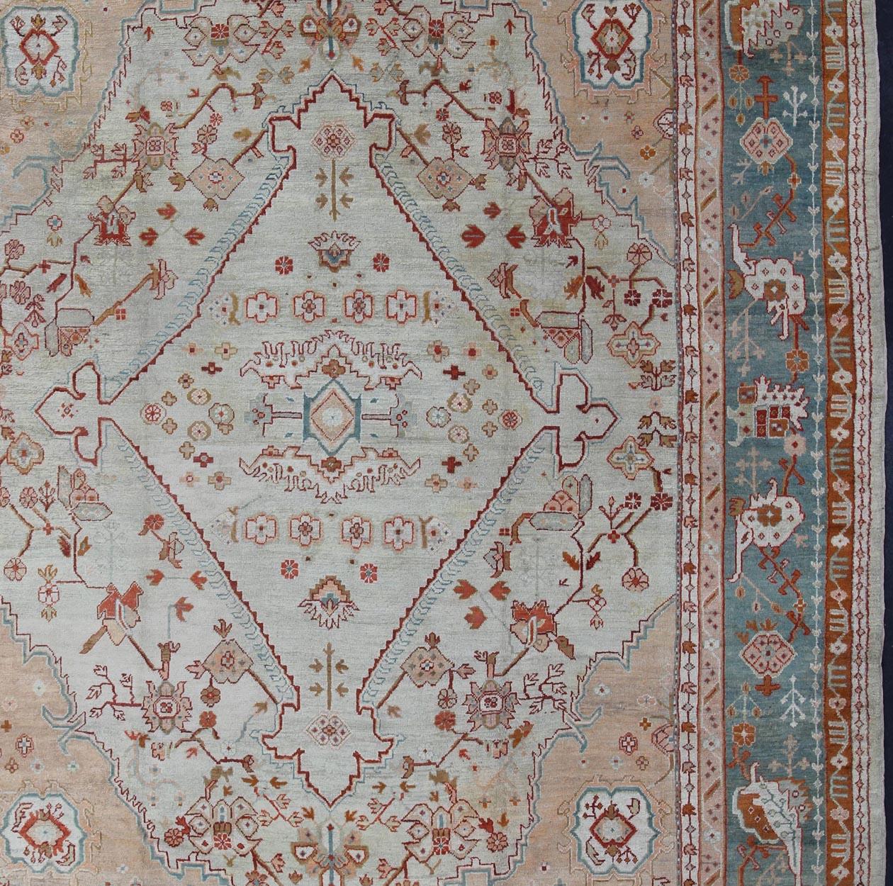 Antique Turkish Oushak rug in ice blue, taupe background and teal border. Keivan Woven Arts / rug VR-7967, country of origin / type: Turkey / Oushak, circa Early-20th century.
Measures: 12'1 x 14'10.
This magnificent Turkish Oushak carpet