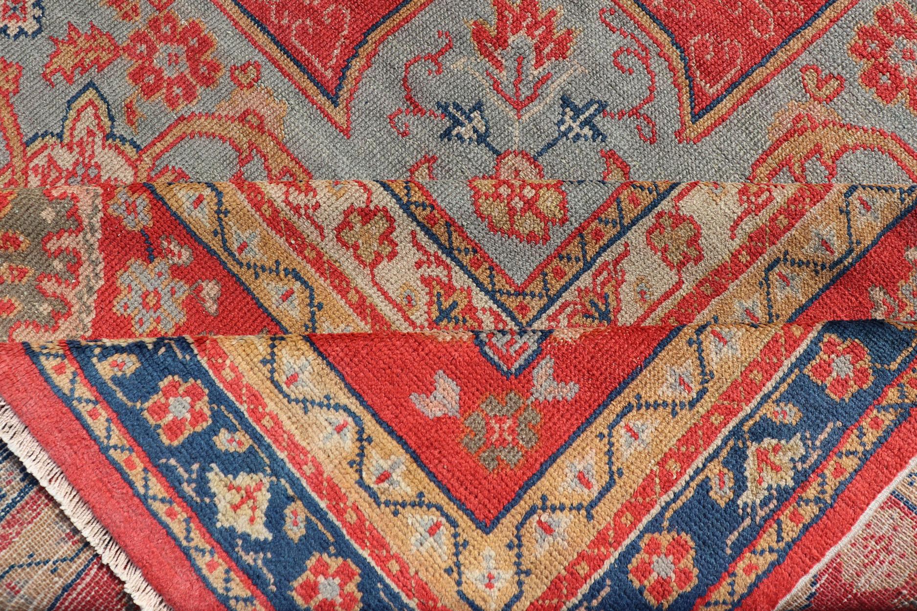 Wool Large Antique Turkish Oushak Rug in Blue and Red with Ornate Medallion Design For Sale