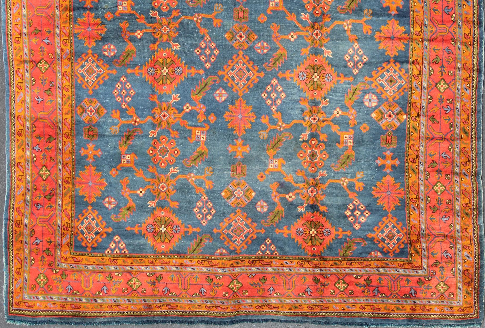 Antique Turkish Oushak rug in vibrant blue, red, green with all-over geometric design, kwarugs DAN-A19889. Colorful Oushak in vibrant colors. 
Measures: 11'3 x 14'10.
This Antique Turkish Oushak rug showcases an all-over geometric sunburst design