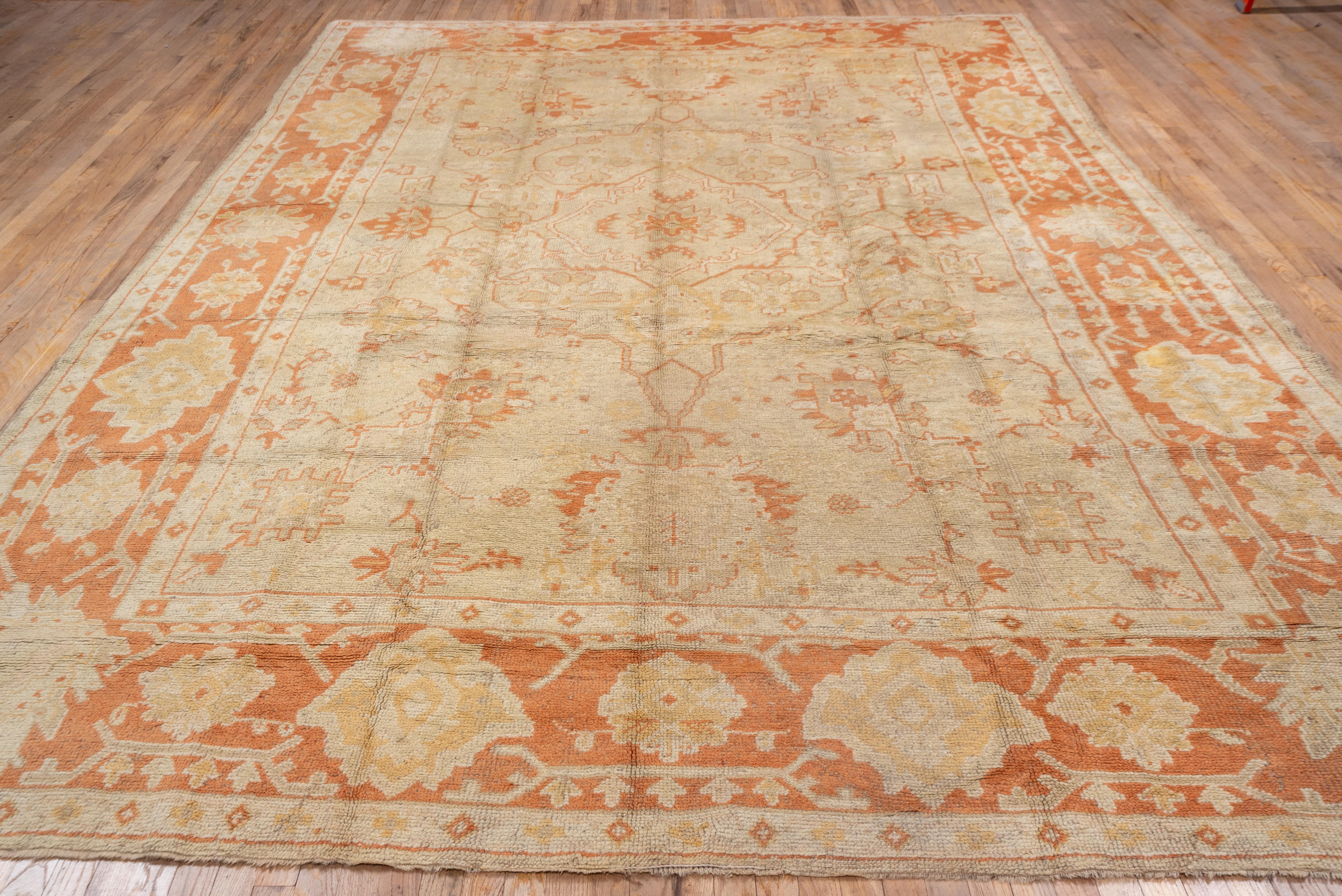 The definitive tangerine-rust border of this West Anatolian coarsely woven piece shows cartouches and corner ragged palmettes, and frames the sandy straw field with an outline octogramme medallion, with side pendant palmettes, accented overall in