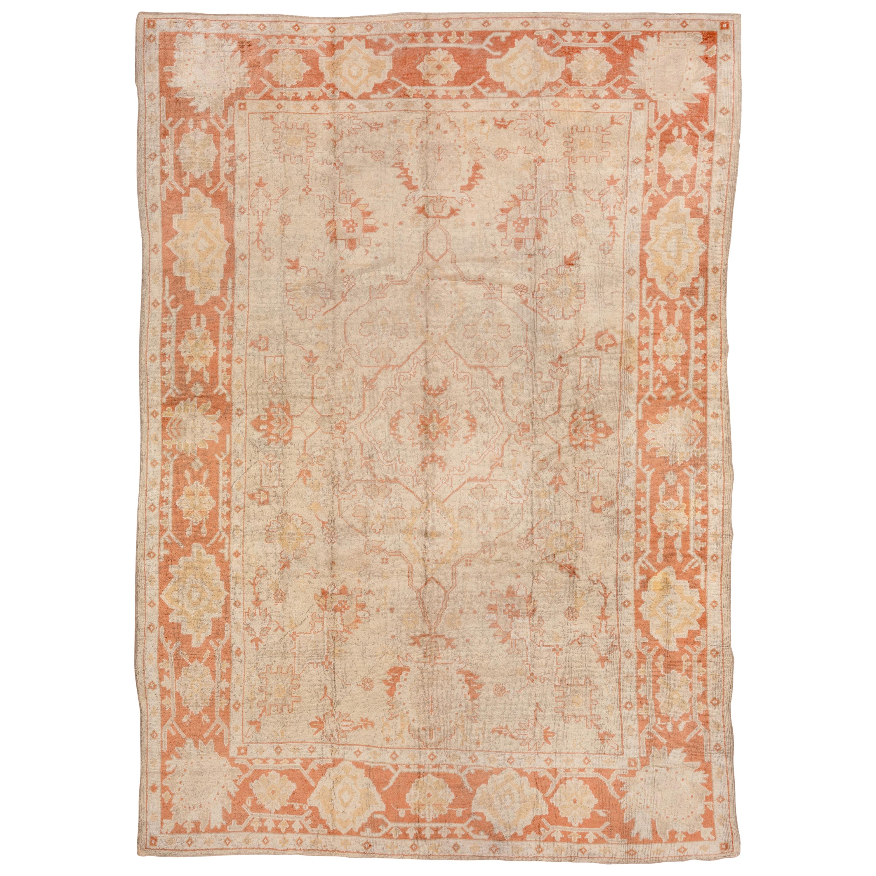 Antique Turkish Oushak Rug, Neutral Field, Orange Borders & Accents, circa 1910s For Sale