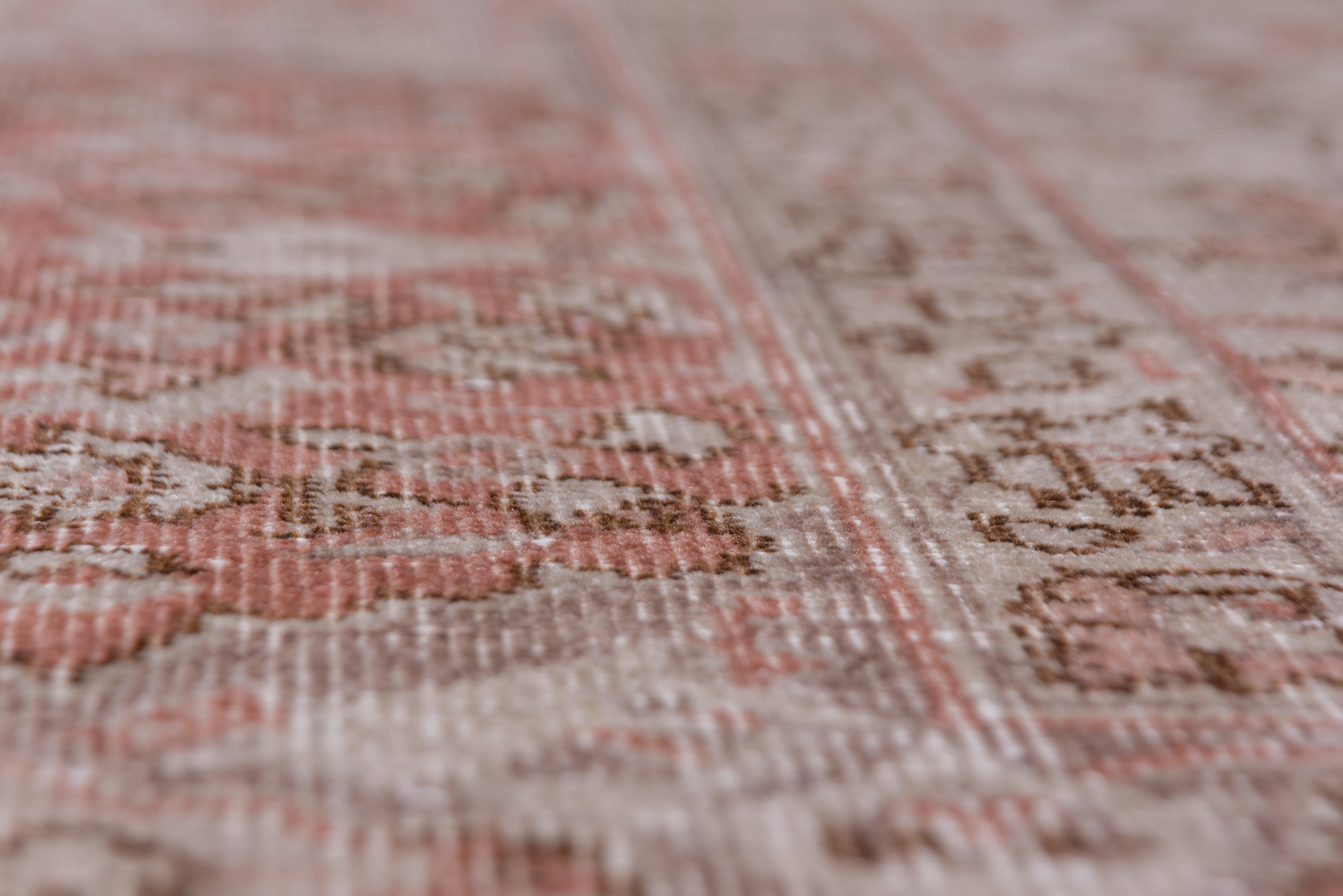 This moderately well-woven Anatolian city carpet features a small flower, leaf and stem allover design on an ecru taupe ground. Red details. Red cartouches dominate the border. Fair to fairly good condition with visible wear.
 