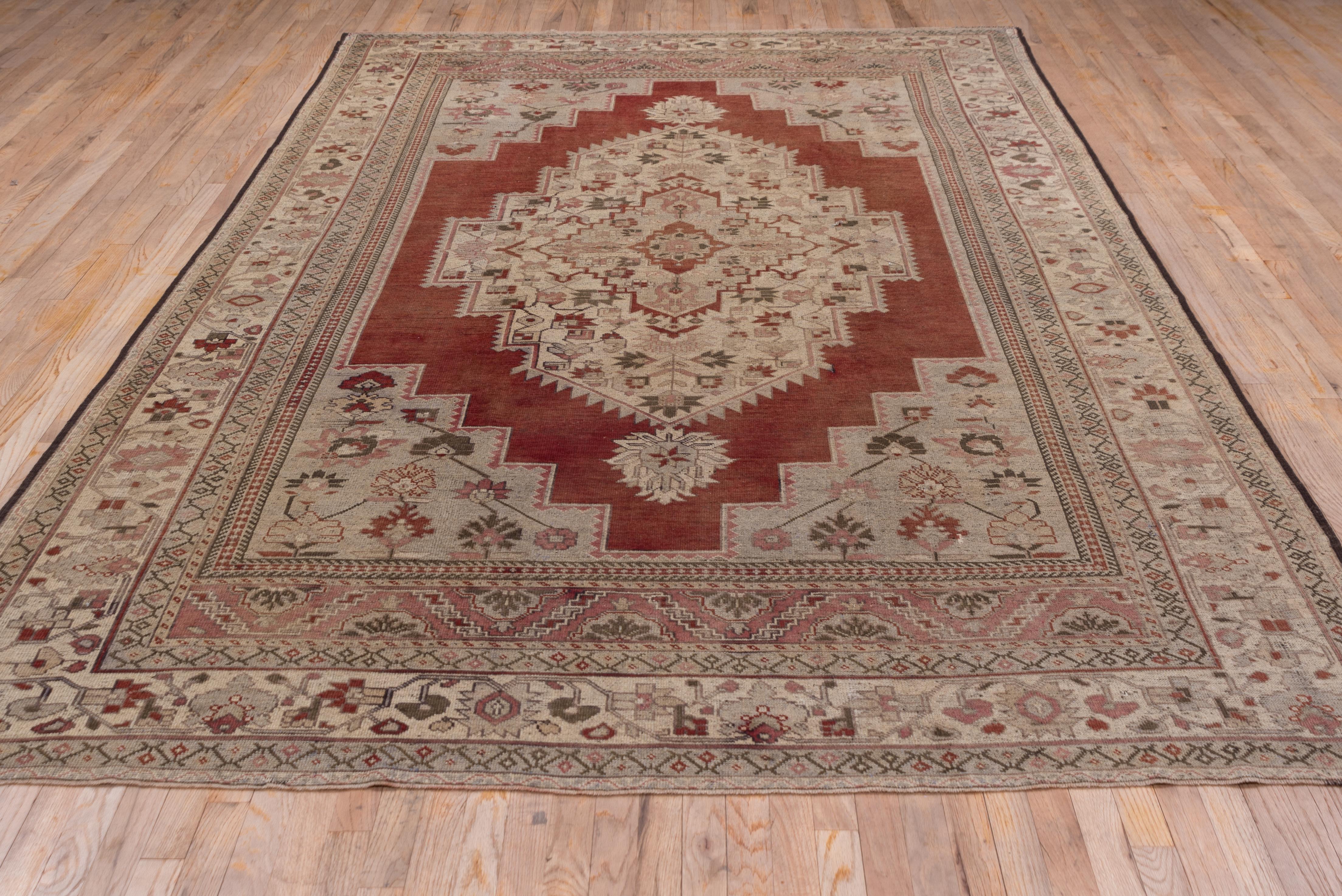 Mid-20th Century Antique Turkish Oushak Rug, Red Outer Field, Ecru Borders and Ecru Medallion For Sale