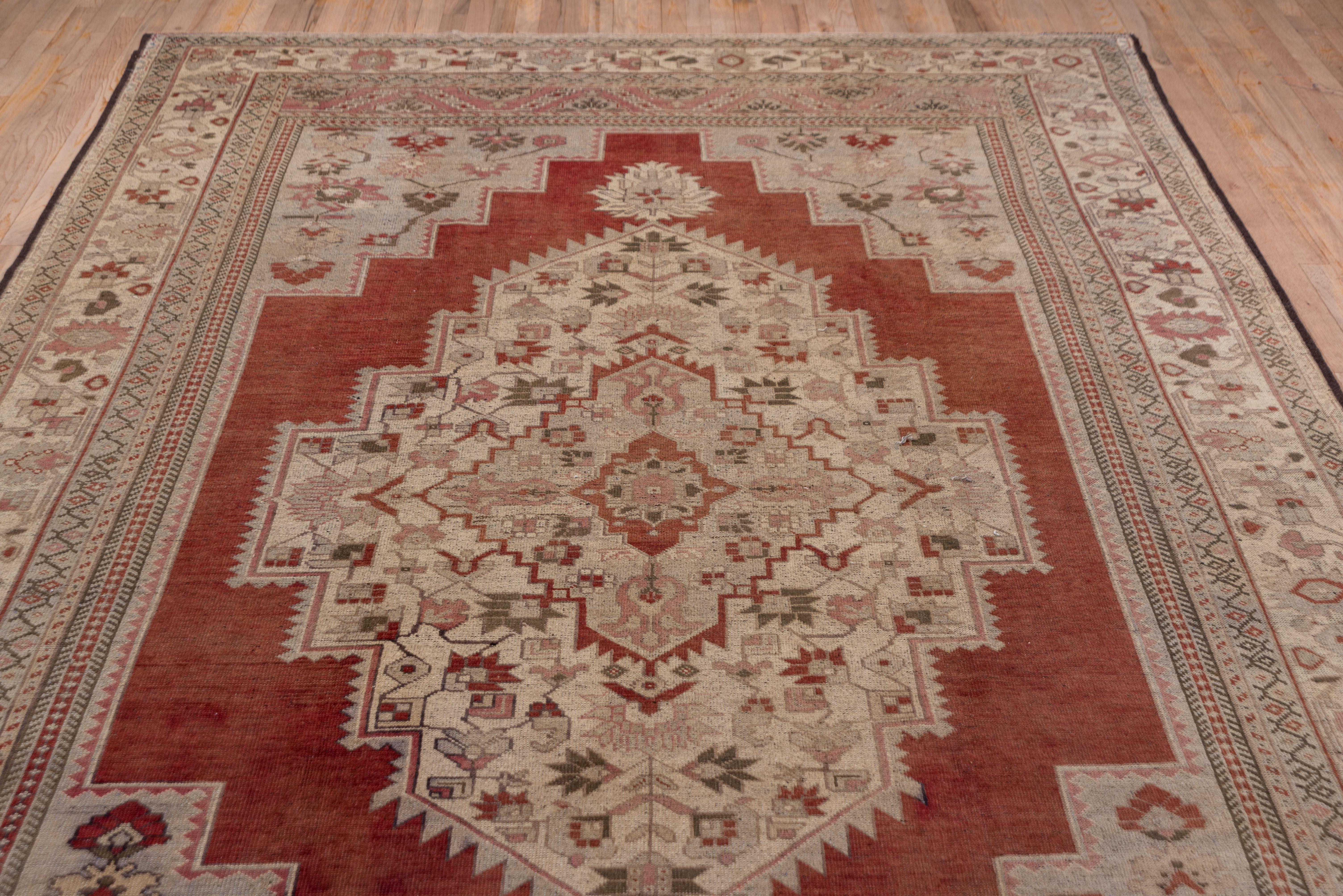 Wool Antique Turkish Oushak Rug, Red Outer Field, Ecru Borders and Ecru Medallion For Sale