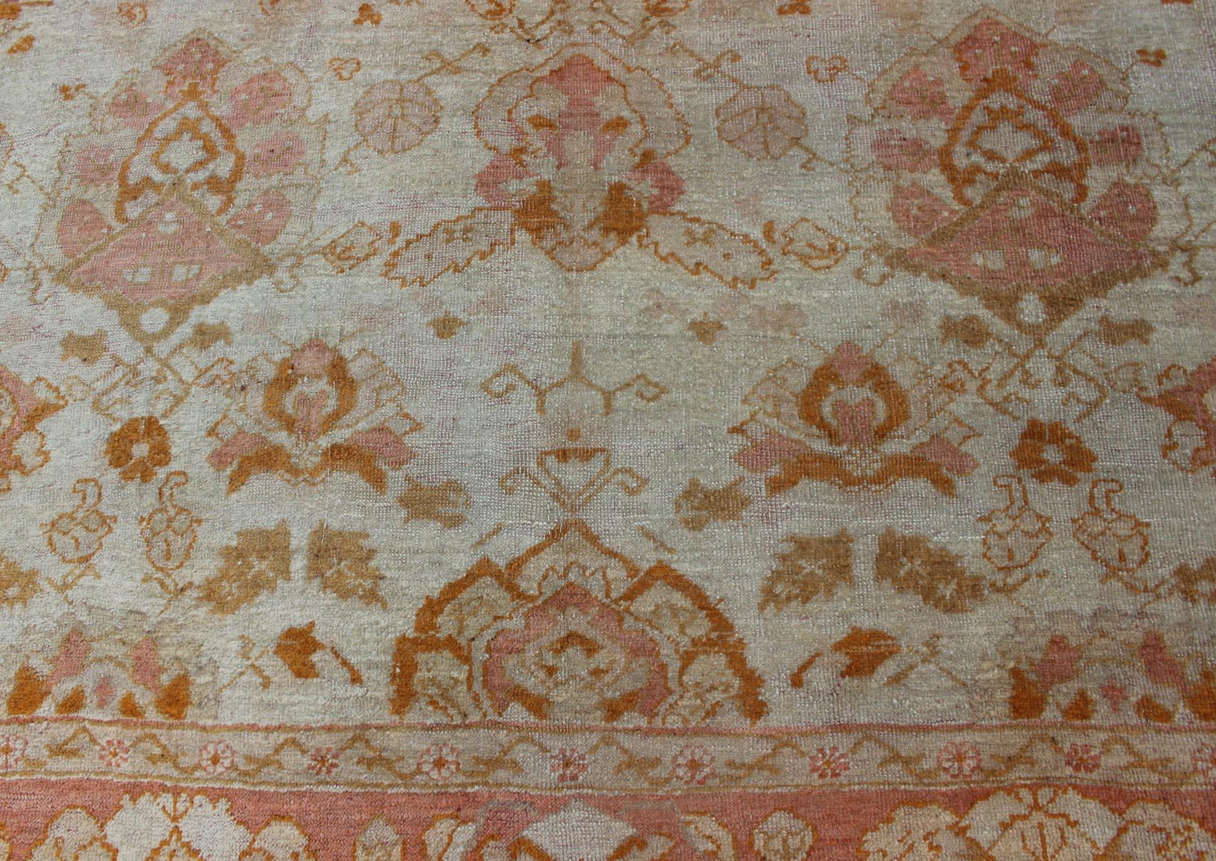 Wool Antique Turkish Oushak Rug with All-Over Design in Ivory and Coral-Salmon For Sale