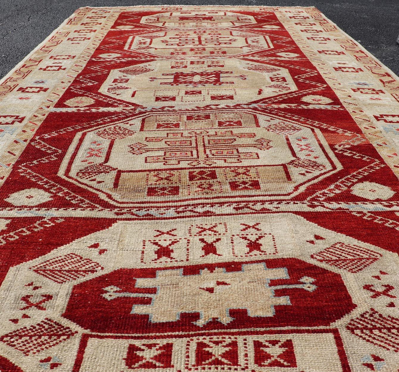 Measures: 4'8 x 9'6
Antique Turkish Oushak Rug with Deep Red, Ivory Tones and Medallions 4'8 x 9'6. Keivan Woven Arts / Rug/ 16-0909, country of origin / type: Turkey / Oushak, circa 1910.

This antique Turkish Oushak rug features a captivating