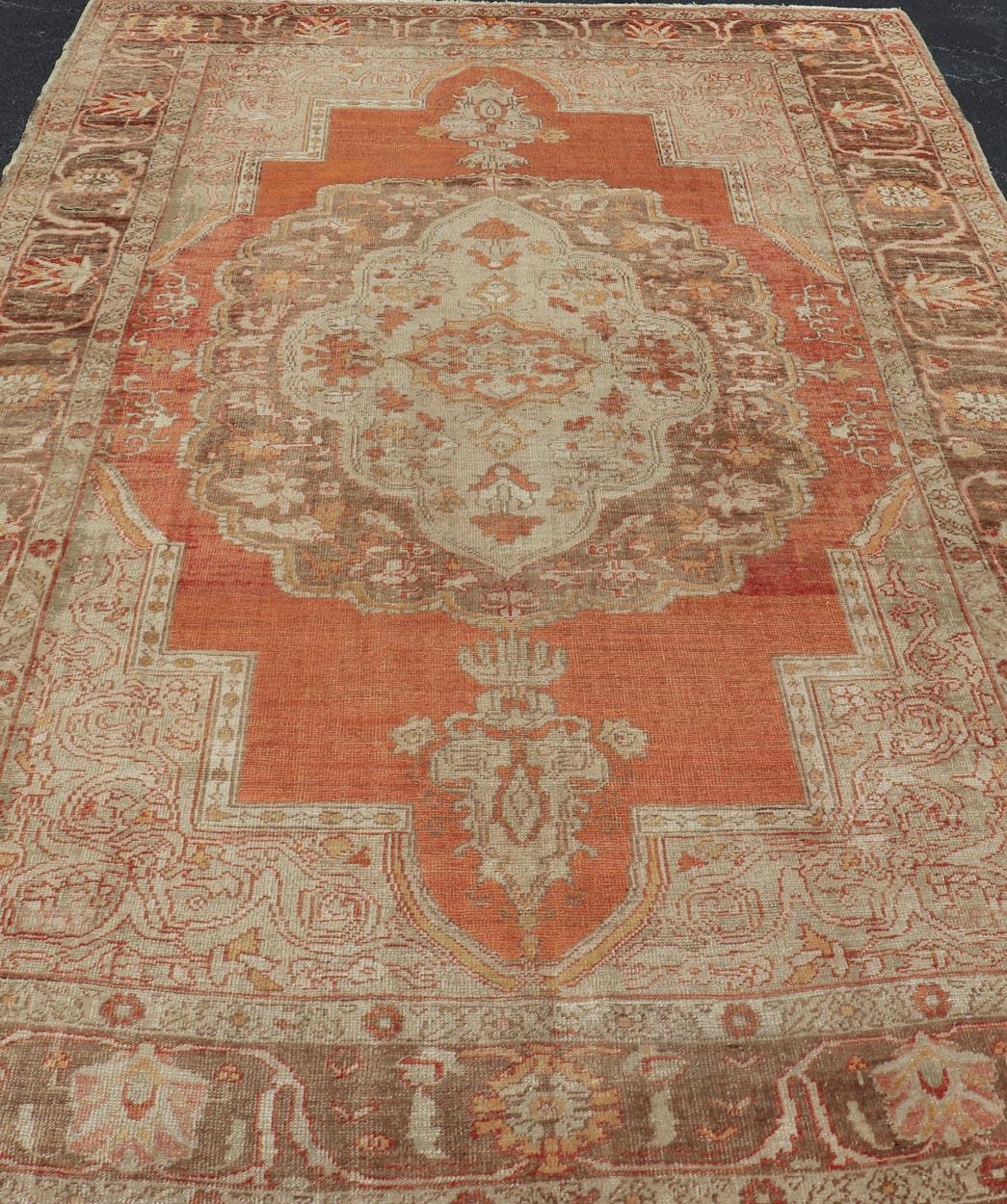  Antique Turkish Oushak Rug with Floral Medallion Burnt Orange and Cream. Keivan Woven Arts / rug NA-639810, country of origin / type: Turkey / Oushak, circa 1910
Measures: 8'2 x 12'11.
This antique Turkish Oushak carpet (circa 1910) features a