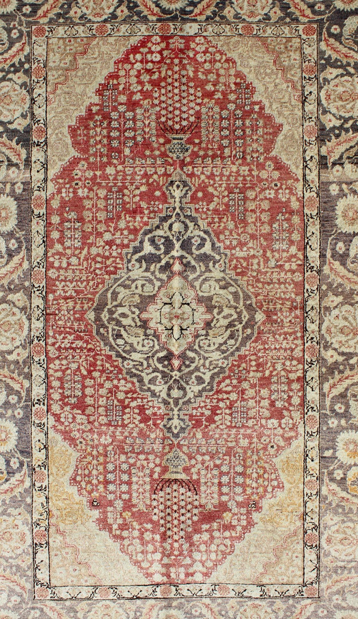 Antique Turkish Oushak rug with Floral Medallion Design in Red and Charcoal

Measures: 4'4 x 7'2

This antique Turkish Oushak carpet features a central medallion design, as well as patterns of smaller floral shapes and botanical elements in the