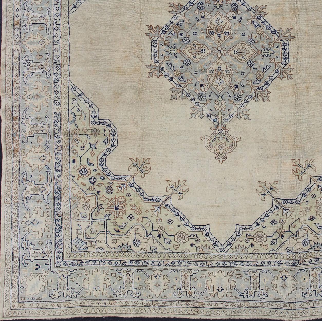 Hand-Knotted Antique Turkish Oushak with Geometric Motifs in Champagne Field and Accent Blue For Sale