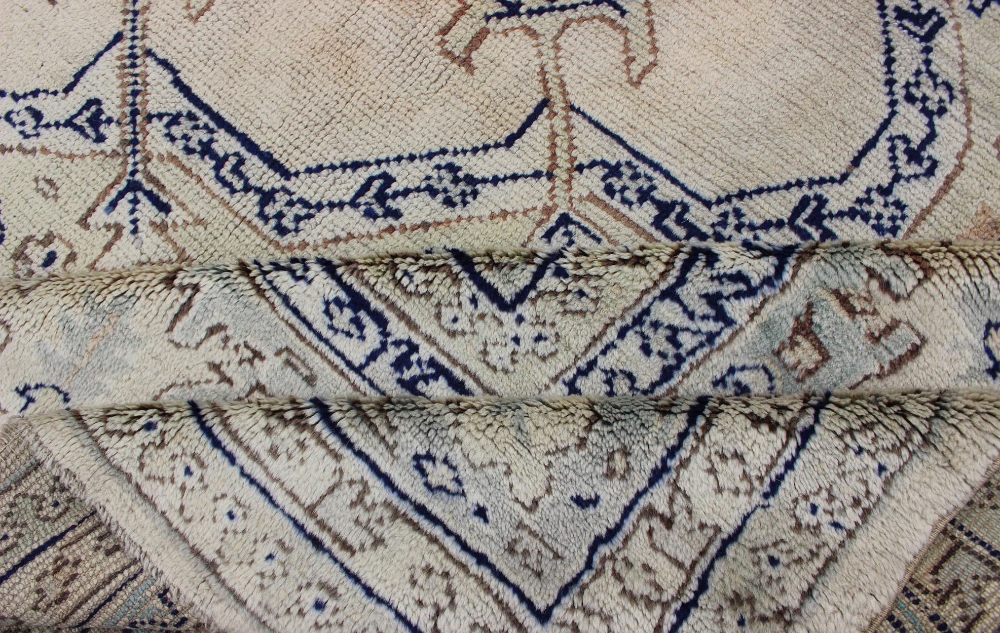 Wool Antique Turkish Oushak with Geometric Motifs in Champagne Field and Accent Blue For Sale