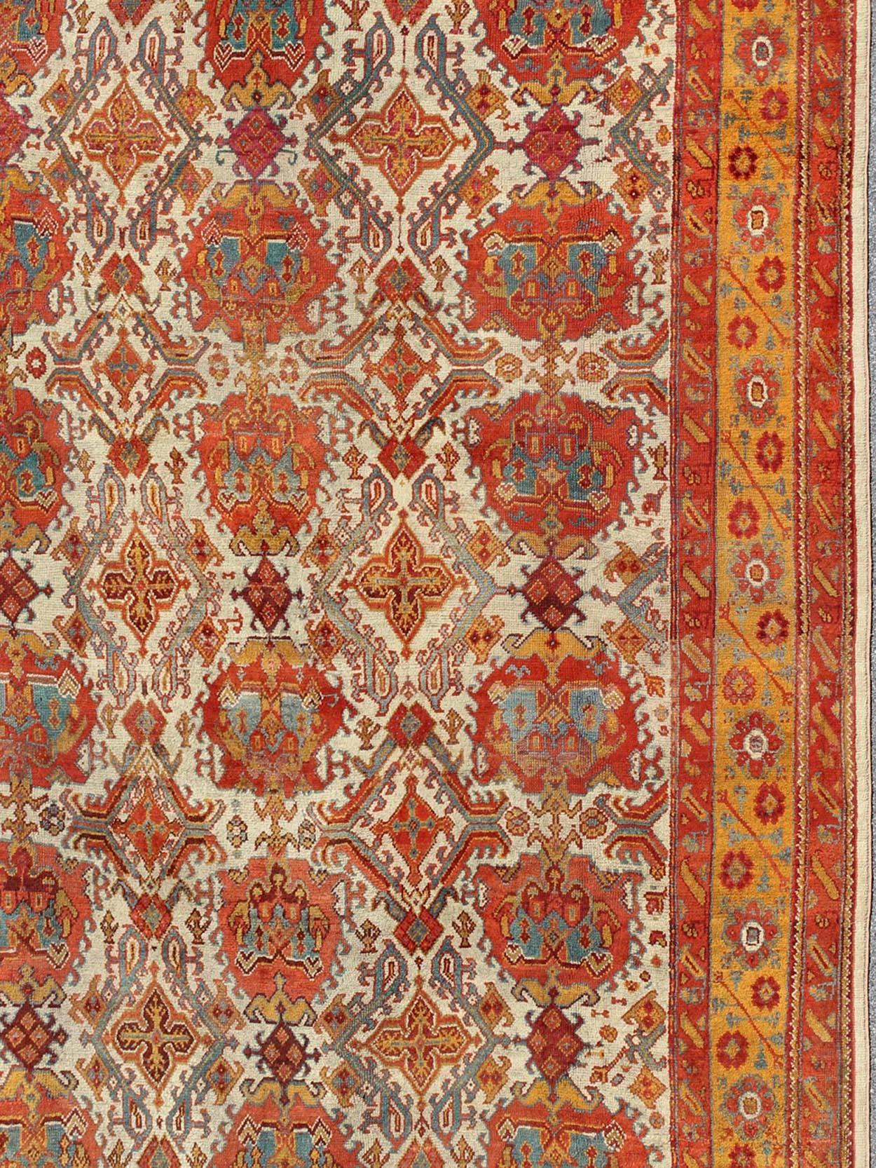 Antique Turkish Oushak Rug with Multi-Medallions in Ivory, Orange, Red & Blue In Good Condition For Sale In Atlanta, GA