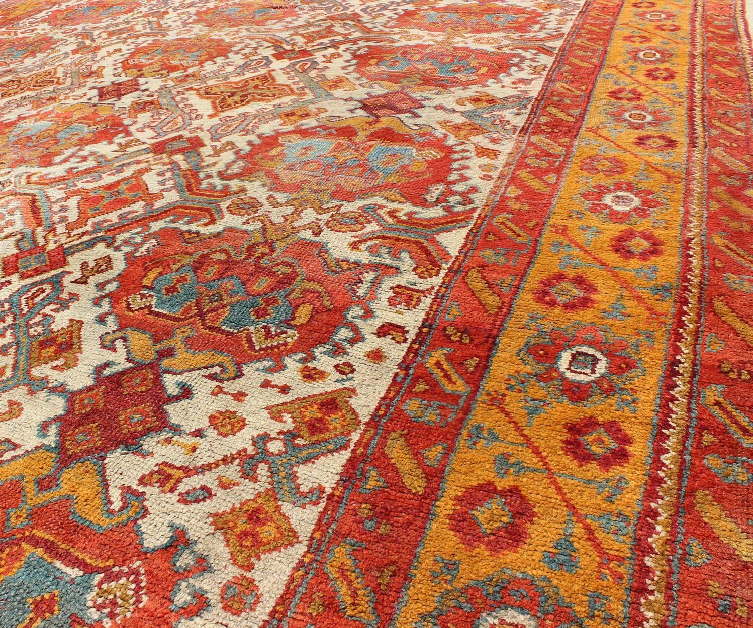 Early 20th Century Antique Turkish Oushak Rug with Multi-Medallions in Ivory, Orange, Red & Blue For Sale