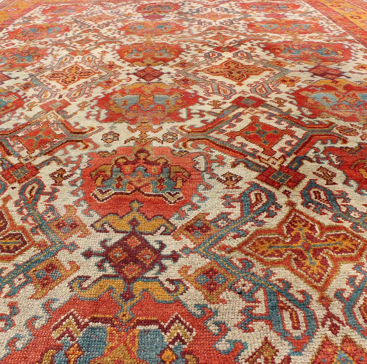 Wool Antique Turkish Oushak Rug with Multi-Medallions in Ivory, Orange, Red & Blue For Sale