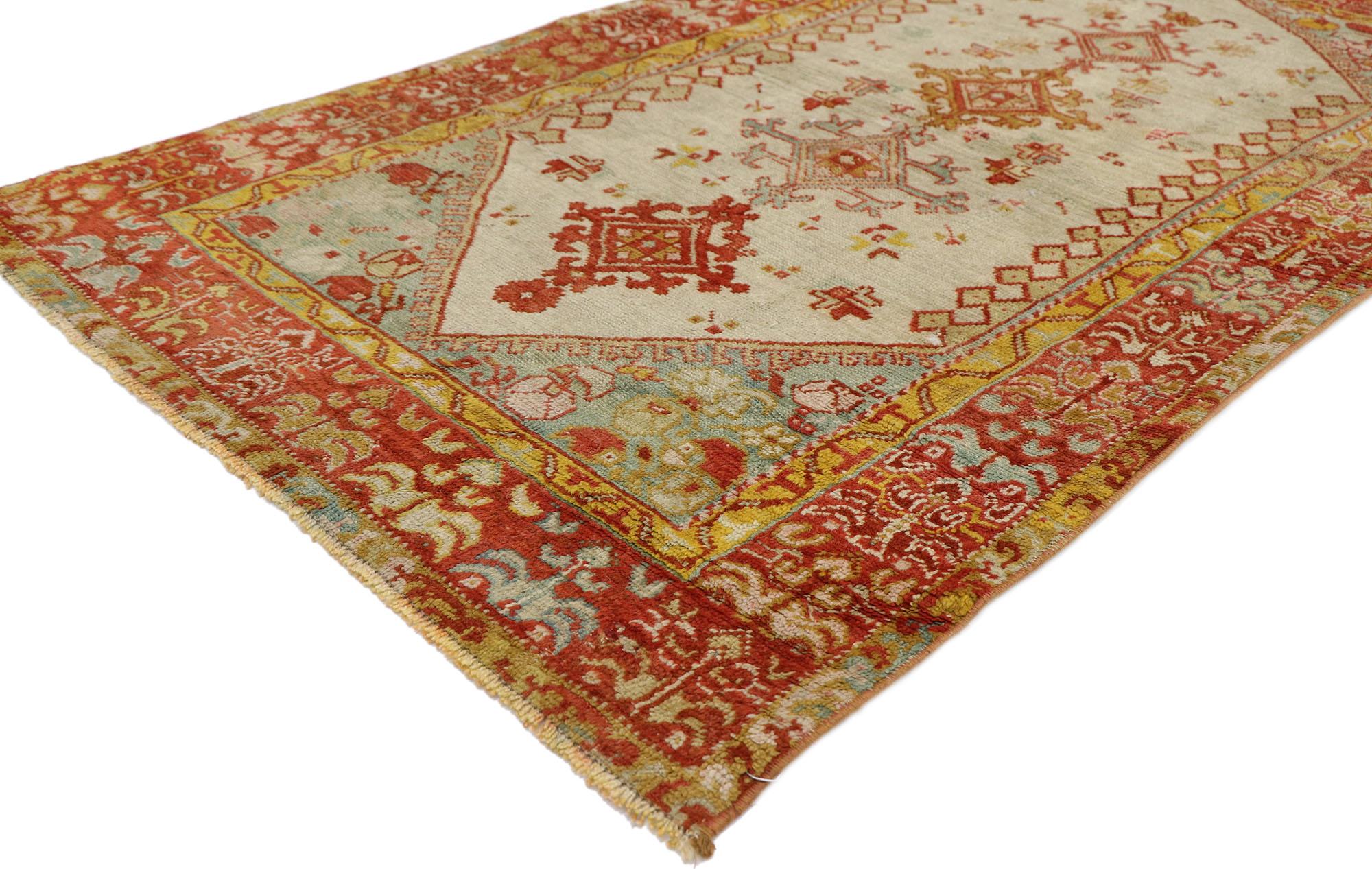 53564, antique Turkish Oushak rug with Northwestern style. With its luminous warm hues and beguiling beauty, this hand-knotted wool antique Oushak rug is immersed in Anatolian history. The abrashed beige field features four stacked lozenges