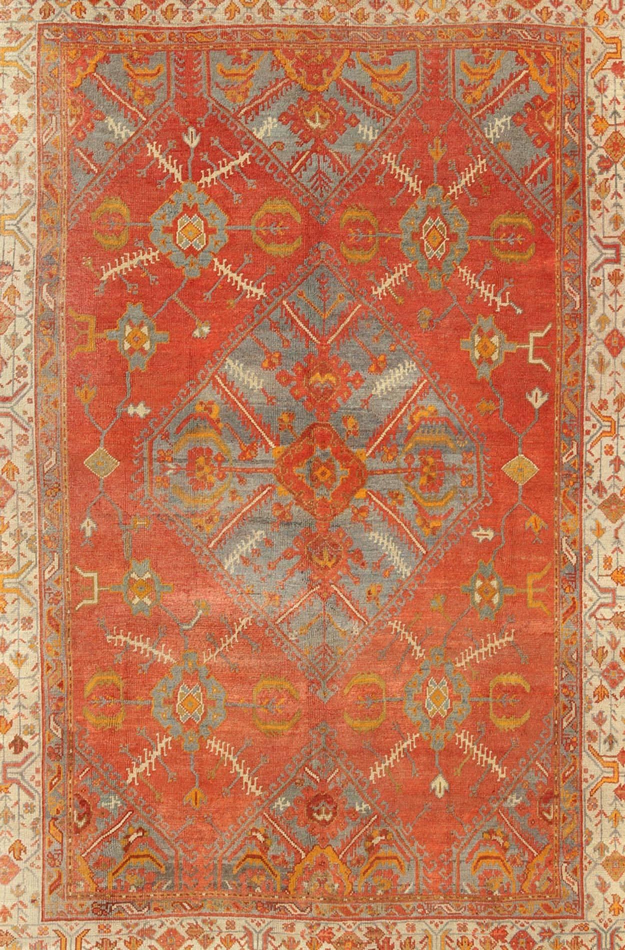 Hand-Knotted Antique Turkish Oushak Rug with Tribal Medallion Design in Terracotta and Blue For Sale
