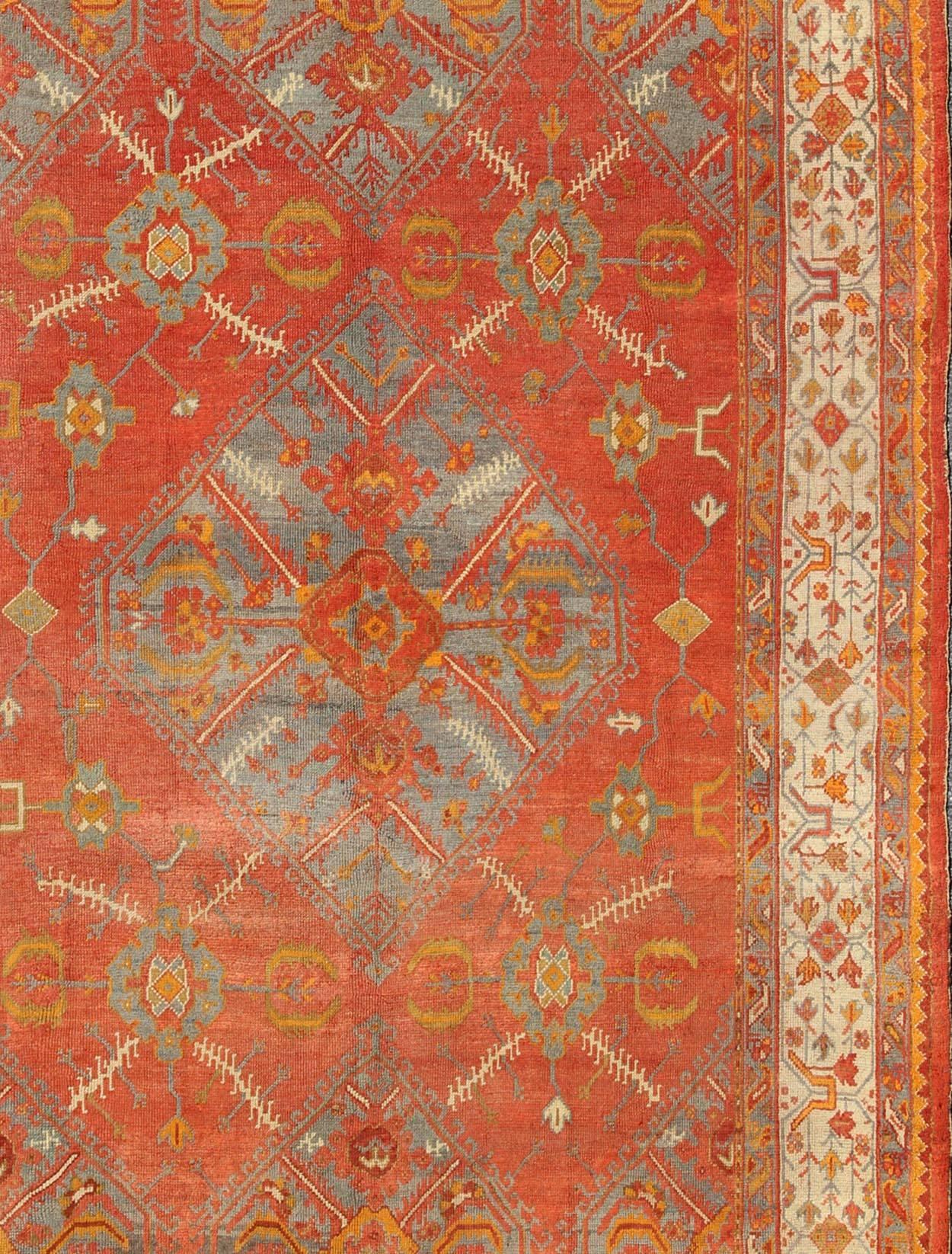 Antique Turkish Oushak Rug with Tribal Medallion Design in Terracotta and Blue In Good Condition For Sale In Atlanta, GA