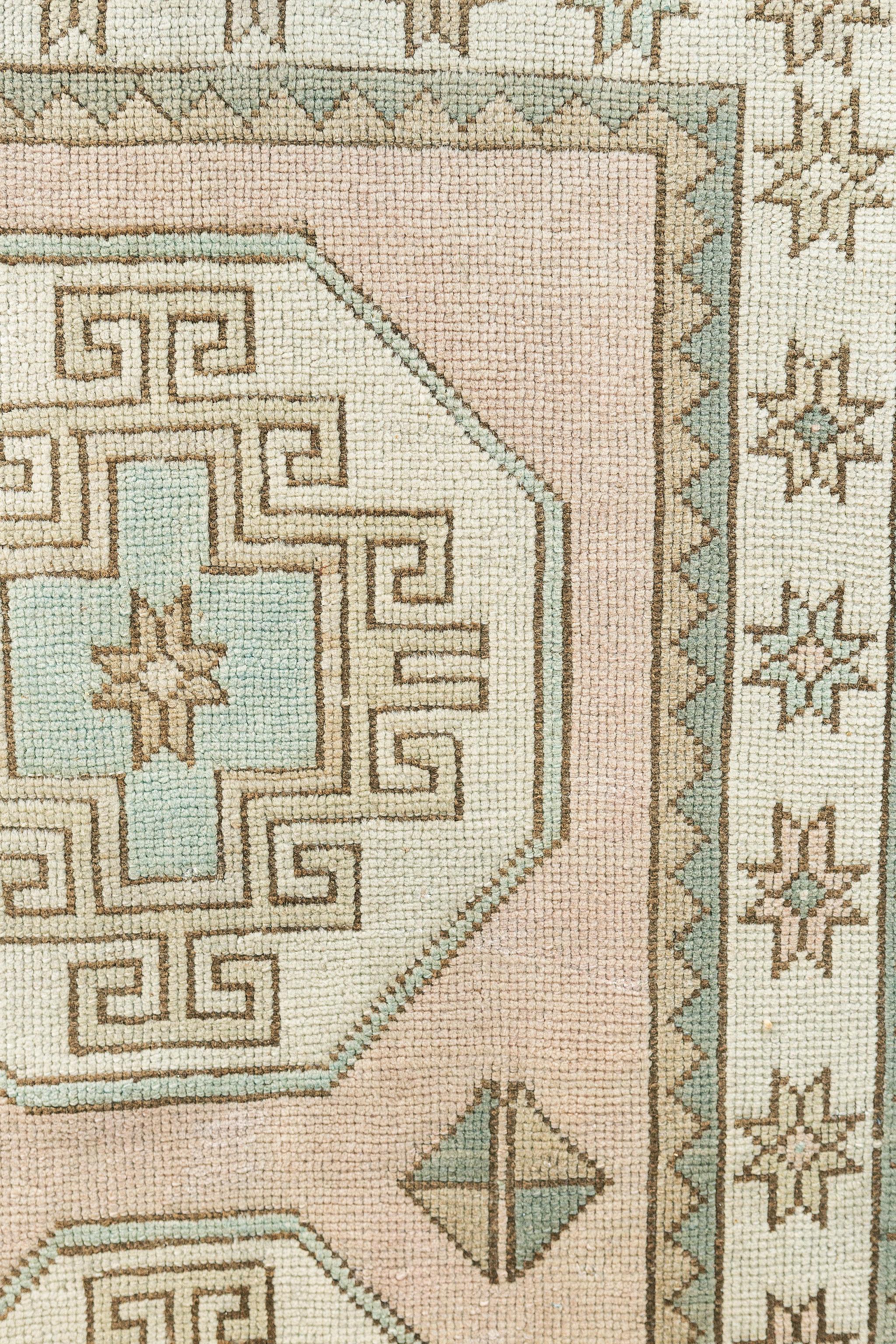 A simplicity through its beauty of a hand-spun wool Oushak Runner is detailed from the blushing pink to the coldest cream of the geometric elements and medallions. It creates a soulful balance of everything from modern decor to contemporary