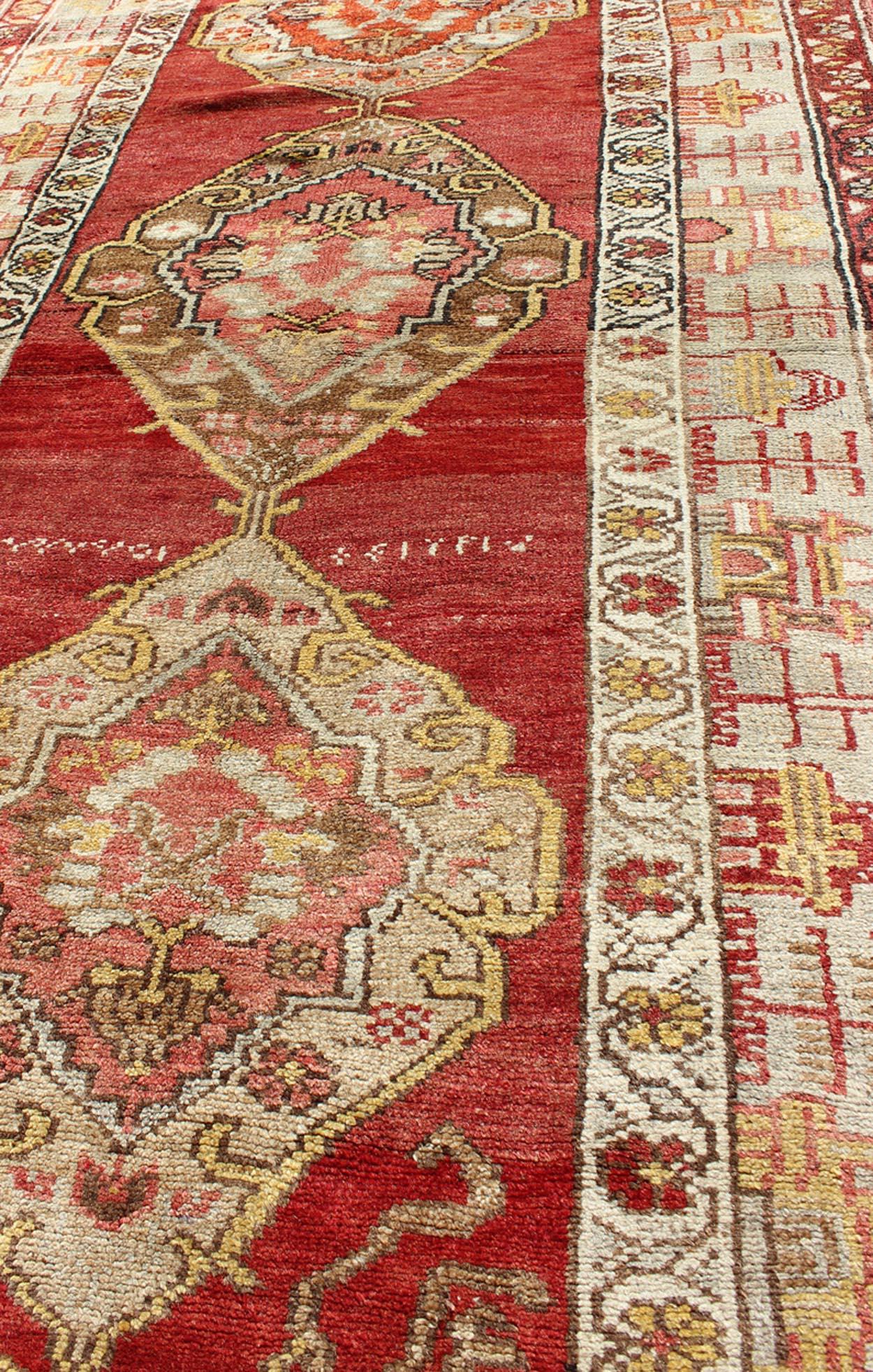 Wool Antique Turkish Oushak Runner In Red Background with Neutral Medallions For Sale