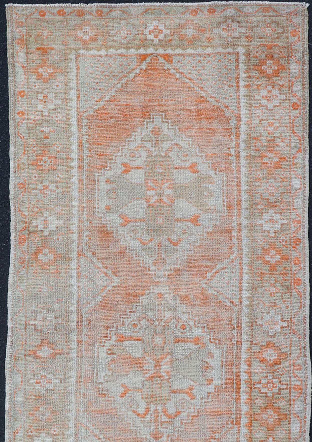 Antique Turkish Oushak runner with floral medallions, Keivan Woven Arts rug/EN-2499, country of origin / type: Turkey / Oushak, circa 1930.

This antique Oushak runner features a unique blend of soft colors scheme and an intricately beautiful