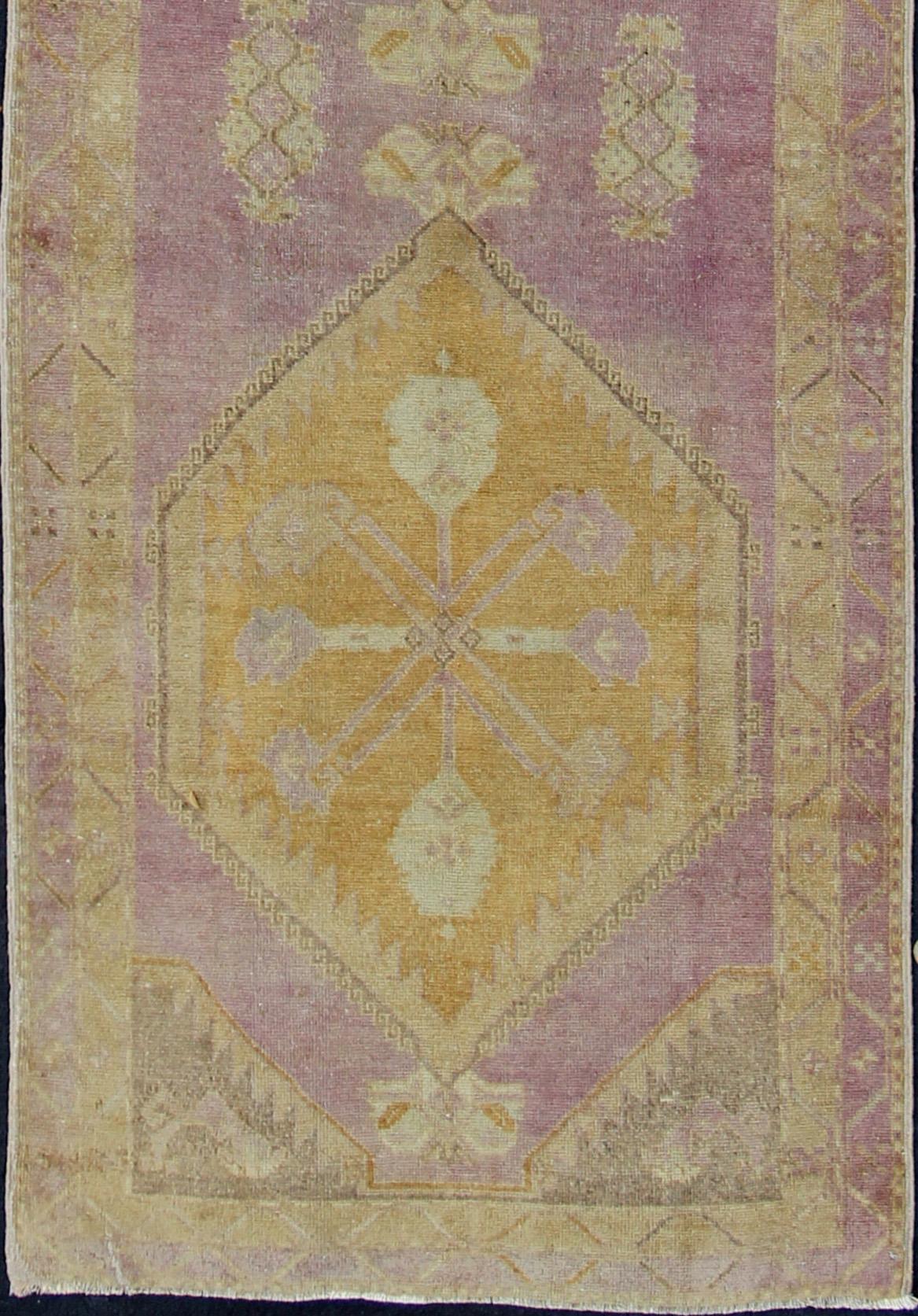 Purple and gold-toned Antique Oushak Runner from Turkey with Medallion Design, rug tu-sim-03, country of origin / type: Turkey / Oushak, circa 1920

This beautiful vintage Oushak runner from 1920s Turkey features a Classic Oushak design, which is