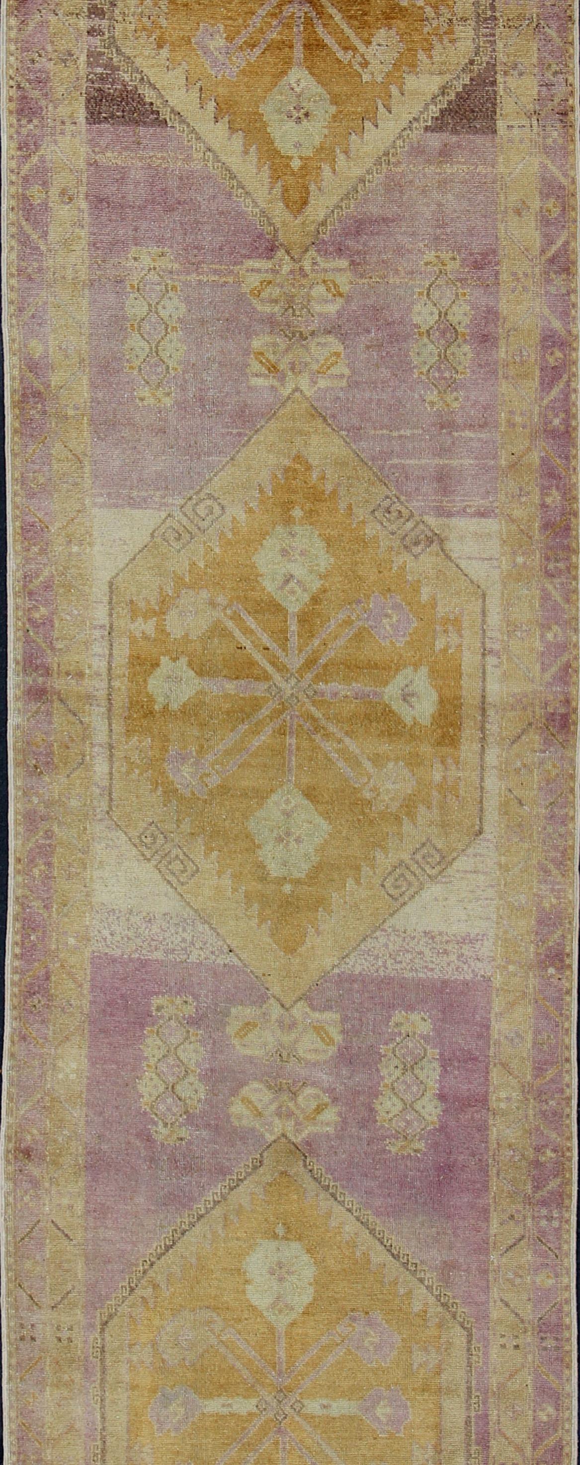 Hand-Knotted Antique Turkish Oushak Runner with Three Geometric Medallions in Purple Tones For Sale