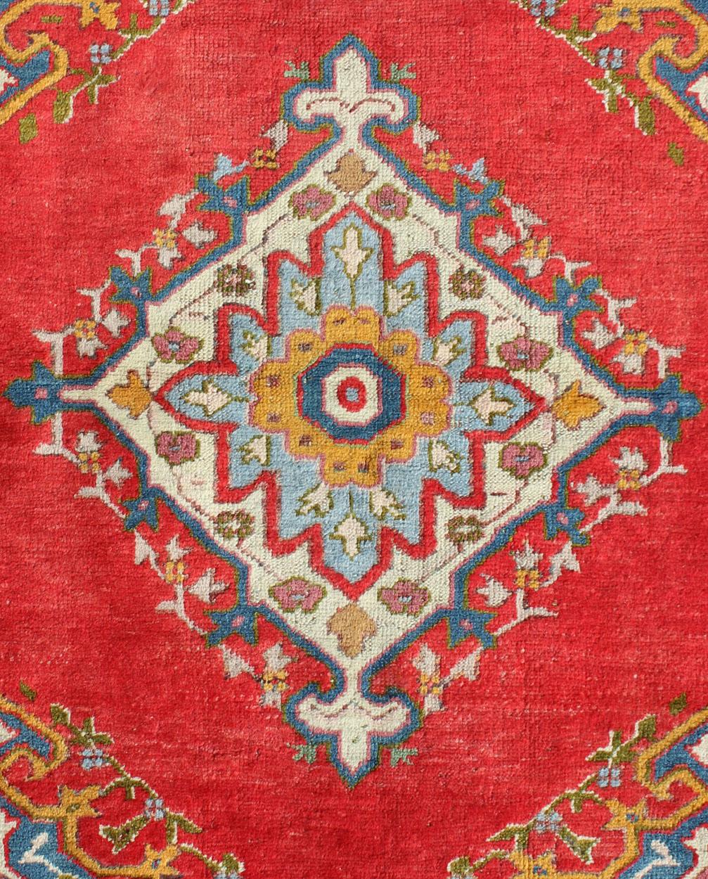 Antique Turkish Oushak small rug in bright red, blue, lavender, orange & green. 
Country of origin: Turkey; Type: Oushak; Design: Medallion, Floral Medallion; Keivan Woven Art: EN-141030, antique Oushak

Measures: 3'5 x 5'3

This antique Oushak  is
