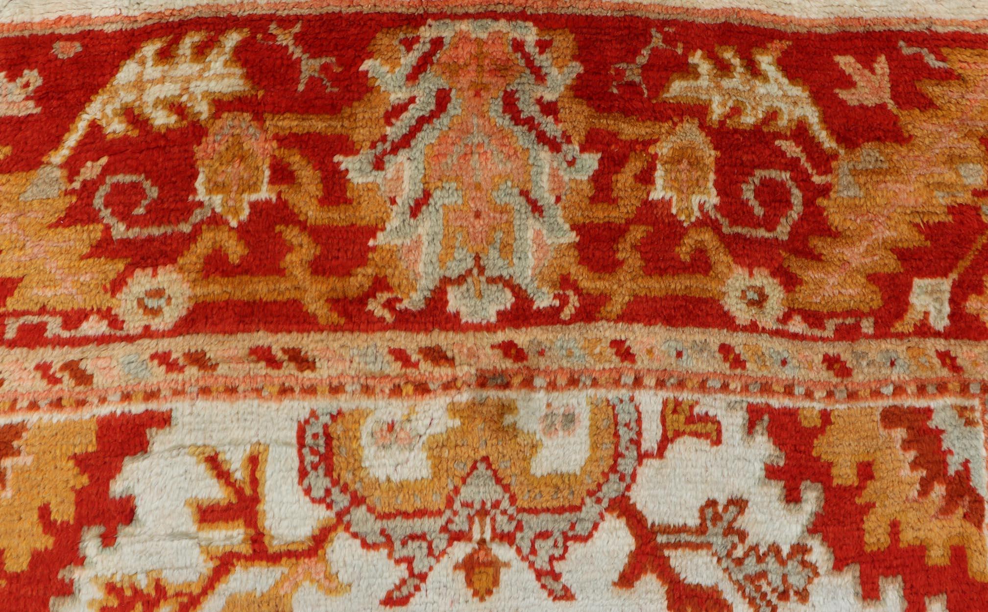Hand-Knotted Antique Turkish Oushak with Elegant Motifs in Red, Ivory, Gold and Salmon Pink For Sale
