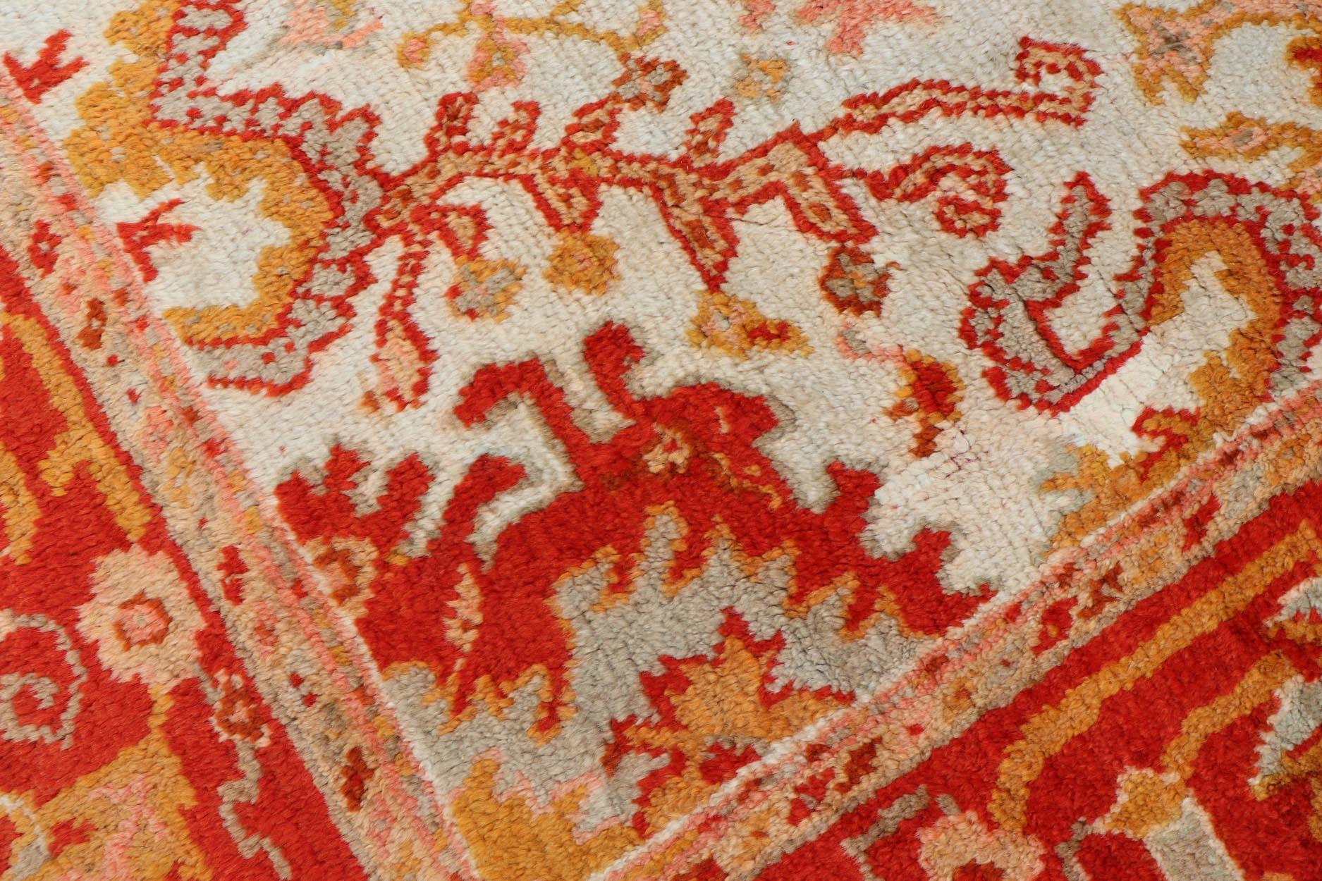 20th Century Antique Turkish Oushak with Elegant Motifs in Red, Ivory, Gold and Salmon Pink For Sale