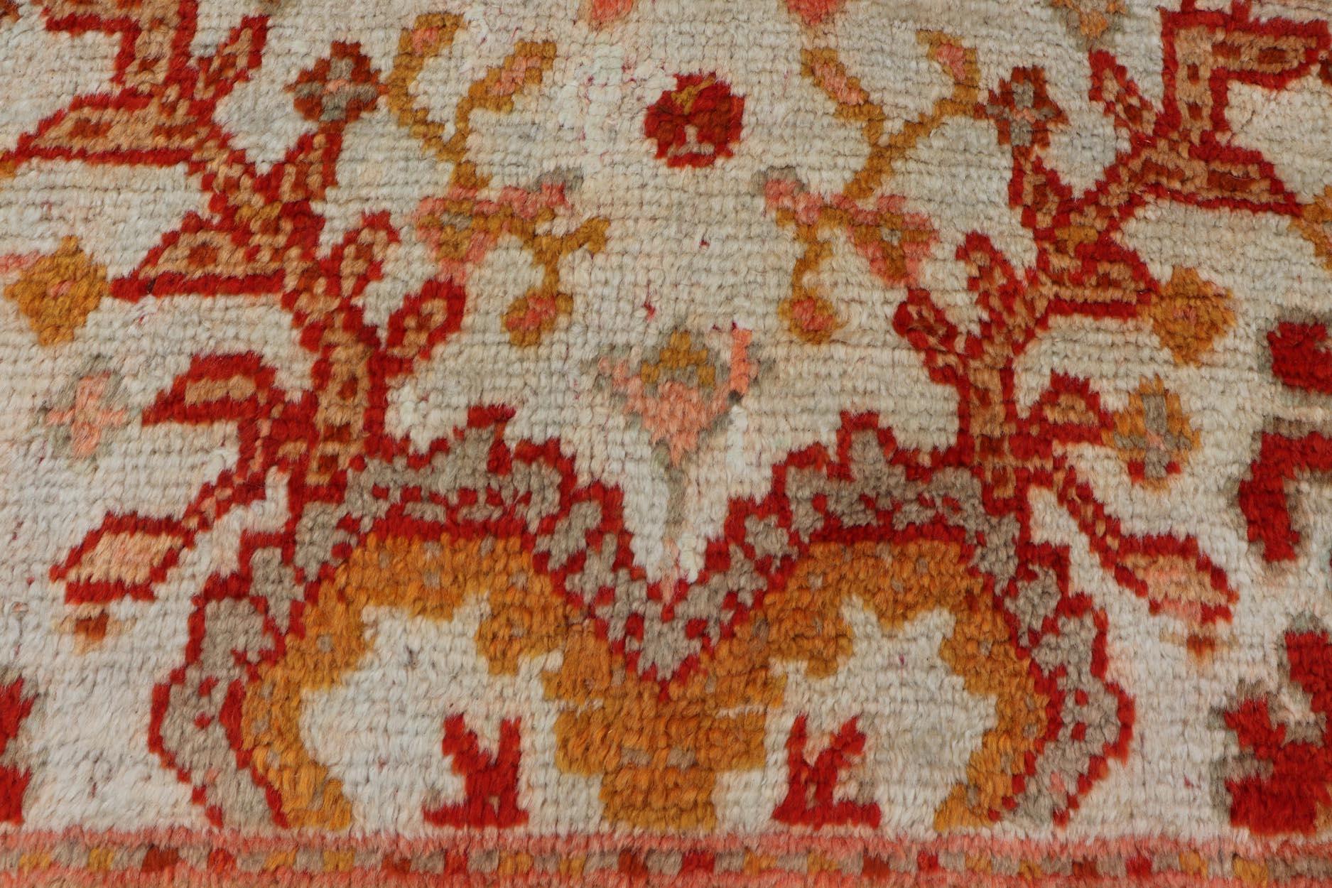 Wool Antique Turkish Oushak with Elegant Motifs in Red, Ivory, Gold and Salmon Pink For Sale
