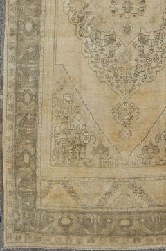 Antique Turkish Oushak with Stylized Medallion Design in Muted Neutral Tones