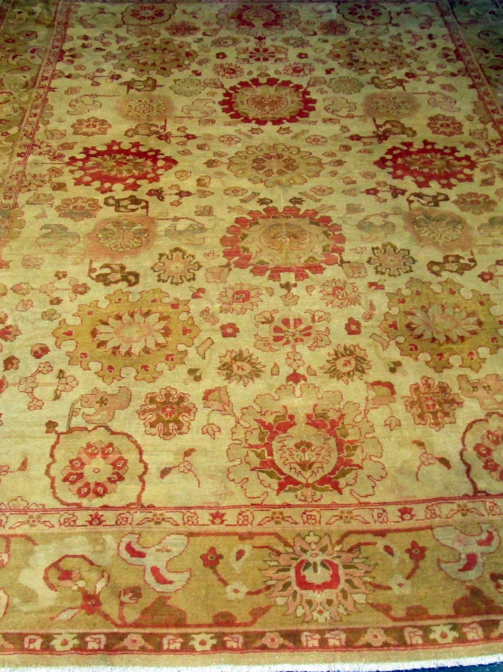 Rare antique Oushak large sized rug of the Turkish family featuring a pronounced abrash (original die color variation or differing color patterns, colorations, and various shades or hues within a rug. It is one of the most common and typical