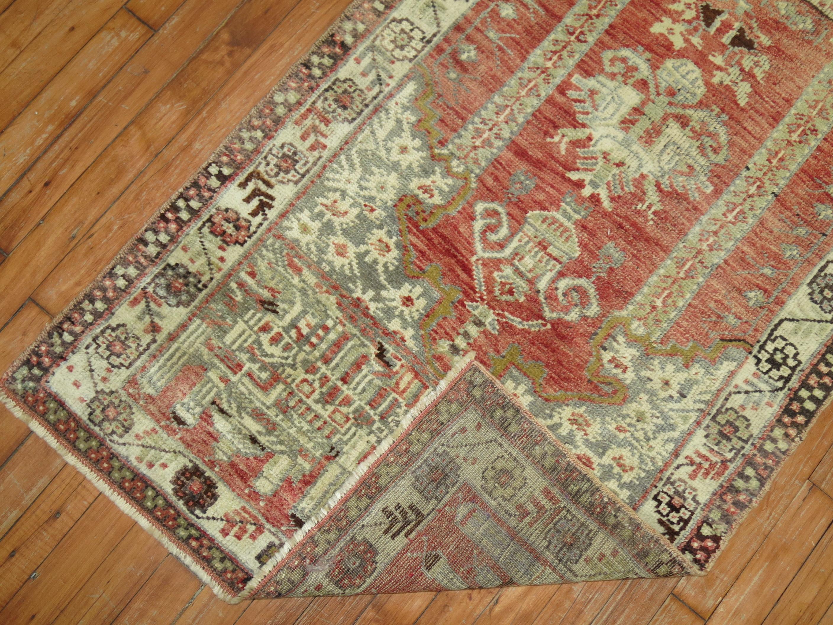 A handmade Turkish rug with a prayer niche design on a rosy red field.

Measures: 2'9