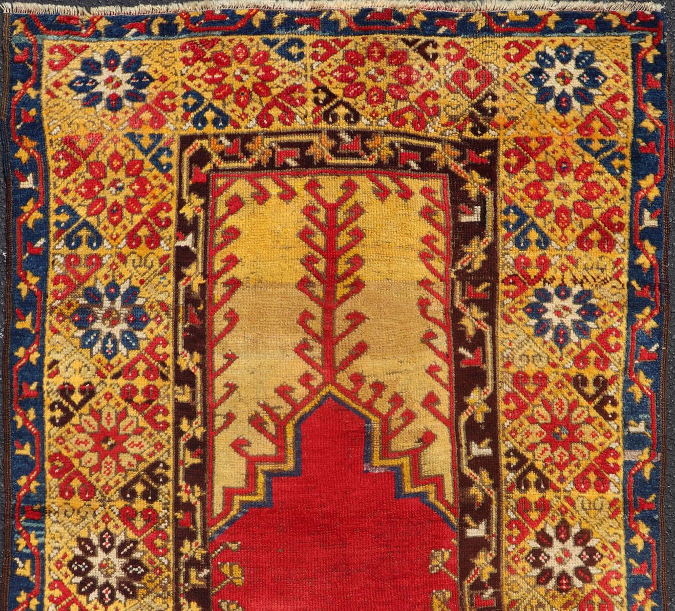 Antique Turkish rug in vibrant colors of blue, red, bright gold and saffron in Prayer design, kwarugs J10-1010. Colorful antique rug in vibrant colors. 
This antique Prayer Design rug from Konya region of Kirsehir in Turkey features a unique blend