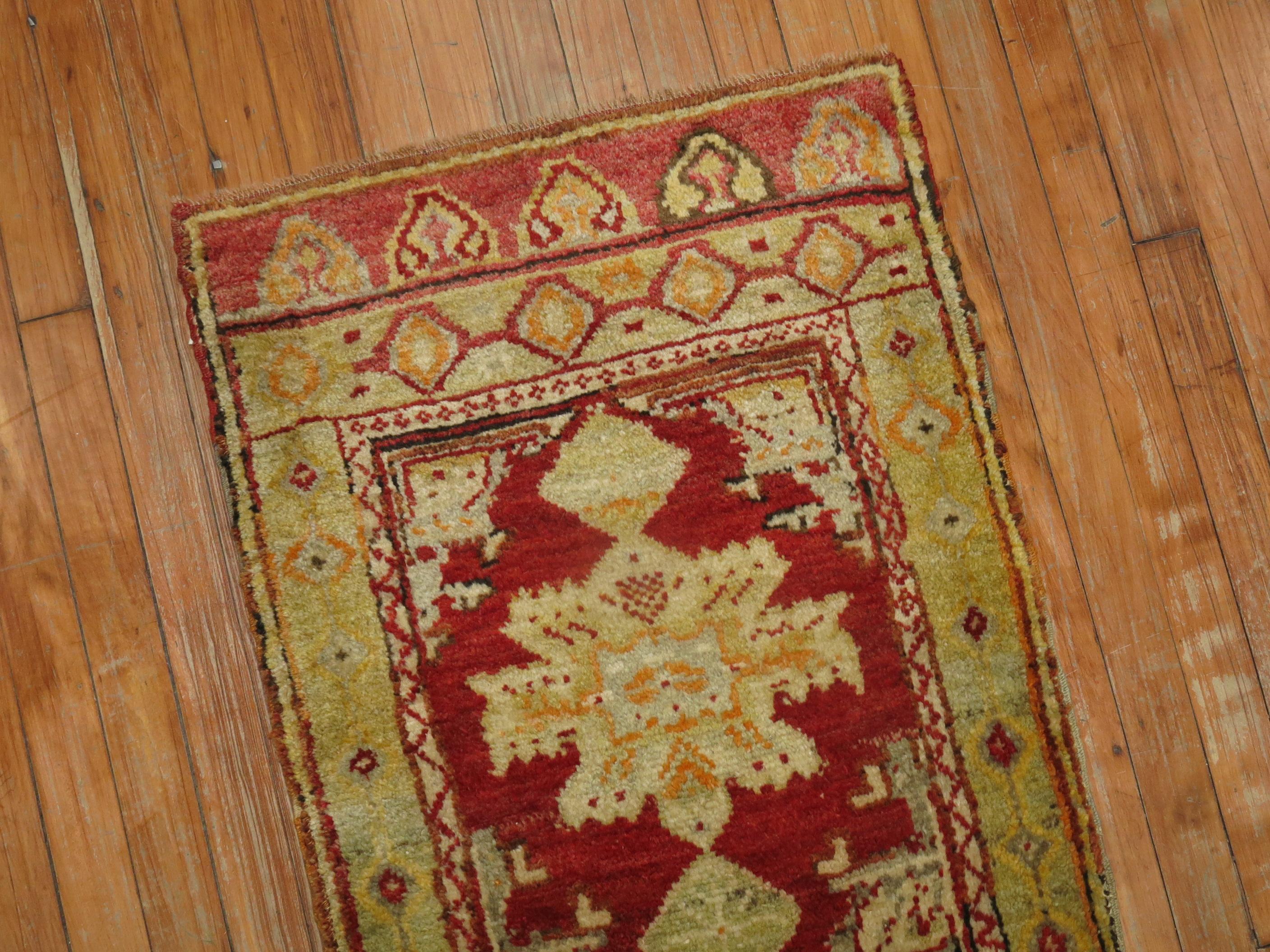 An early 20th century full even pile condition cherry red color Turkish rug.

1'11'' x 3'