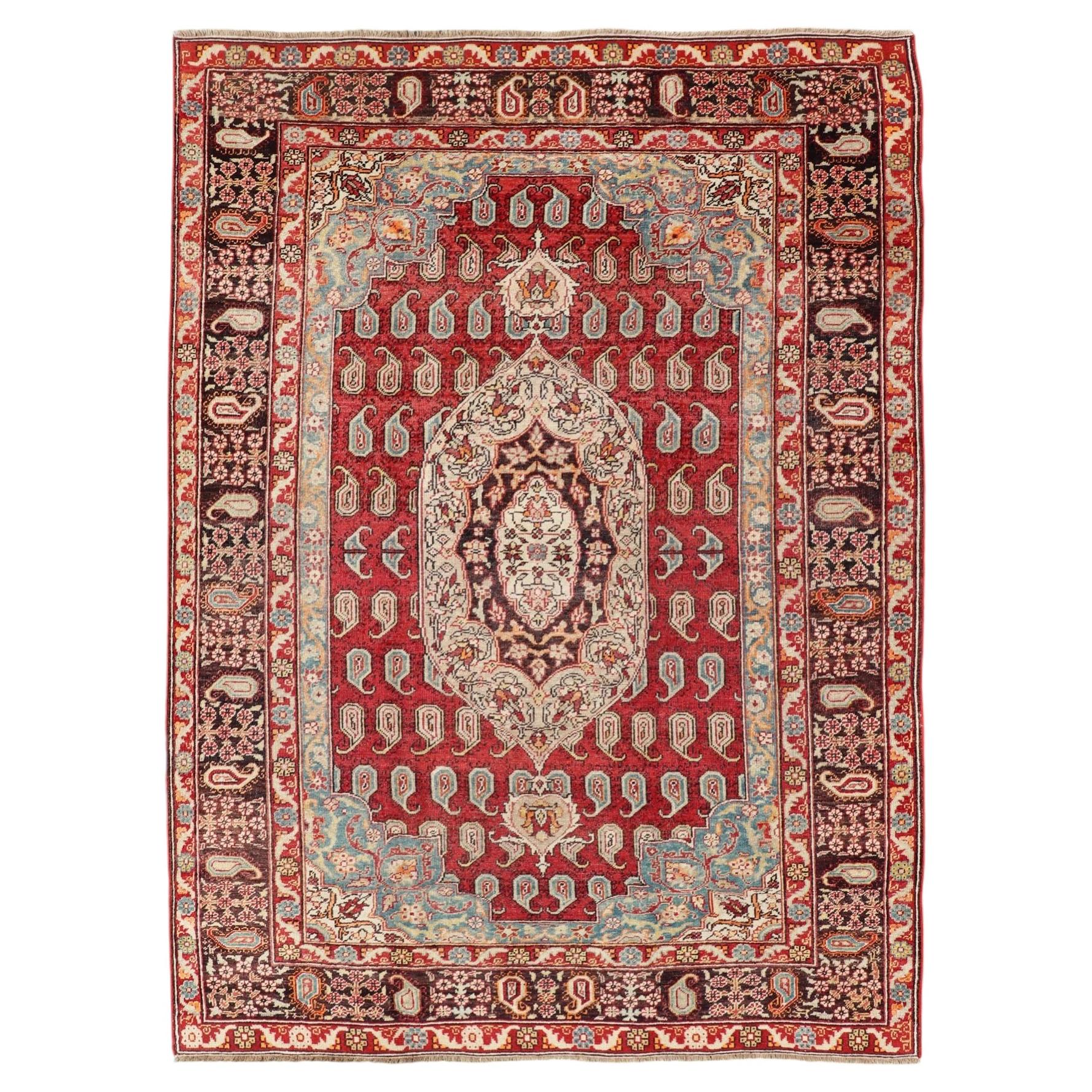 Antique Turkish Rug with Paisley Design in Red, Brown and Blue For Sale