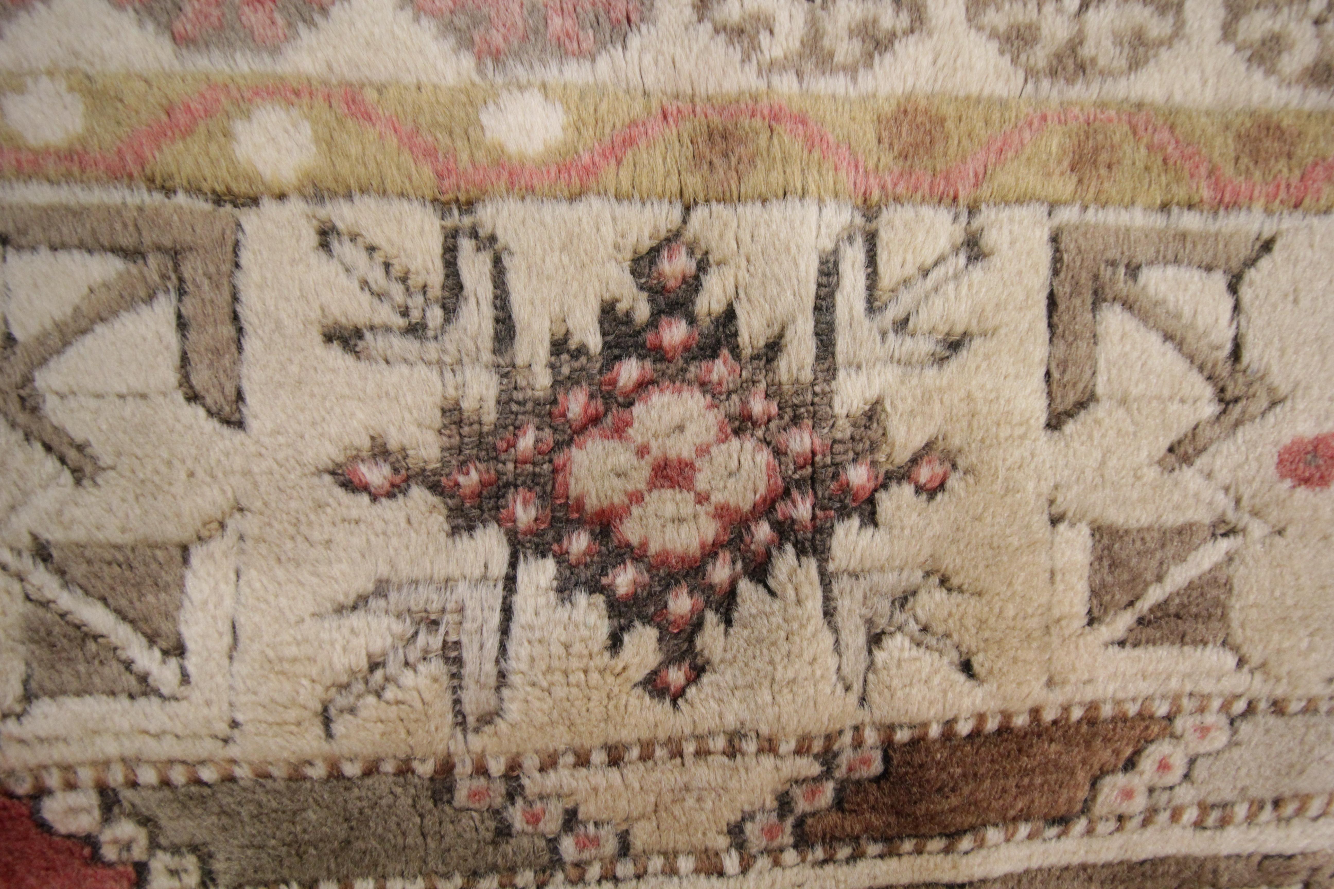 This soft brown colour vintage Milas woven rug rests beautifully upon a field of pale lime green, light grey and brown colours. This geometric rug has a medallion of multi colours and neutrals that takes centre stage and the tribal rug is well