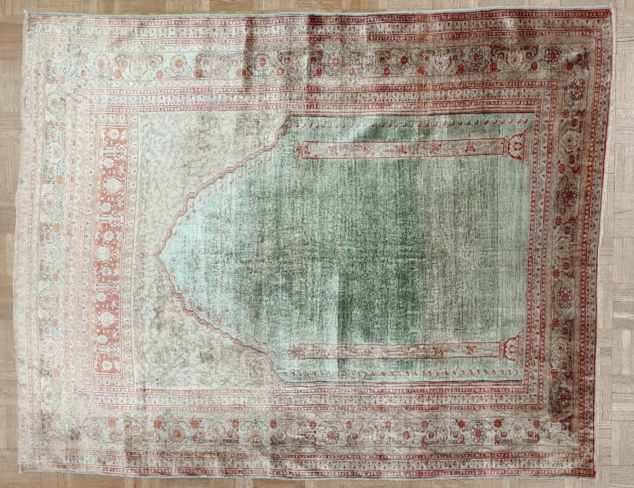 Very rare antique Turkish Silk Ghiordes rug with a prayer design. This rug dates mid-19th century. The field is aqua and there is a lot of terracotta in the border and mihrab. There are about 800 knots per square inch. The pile is a little low in