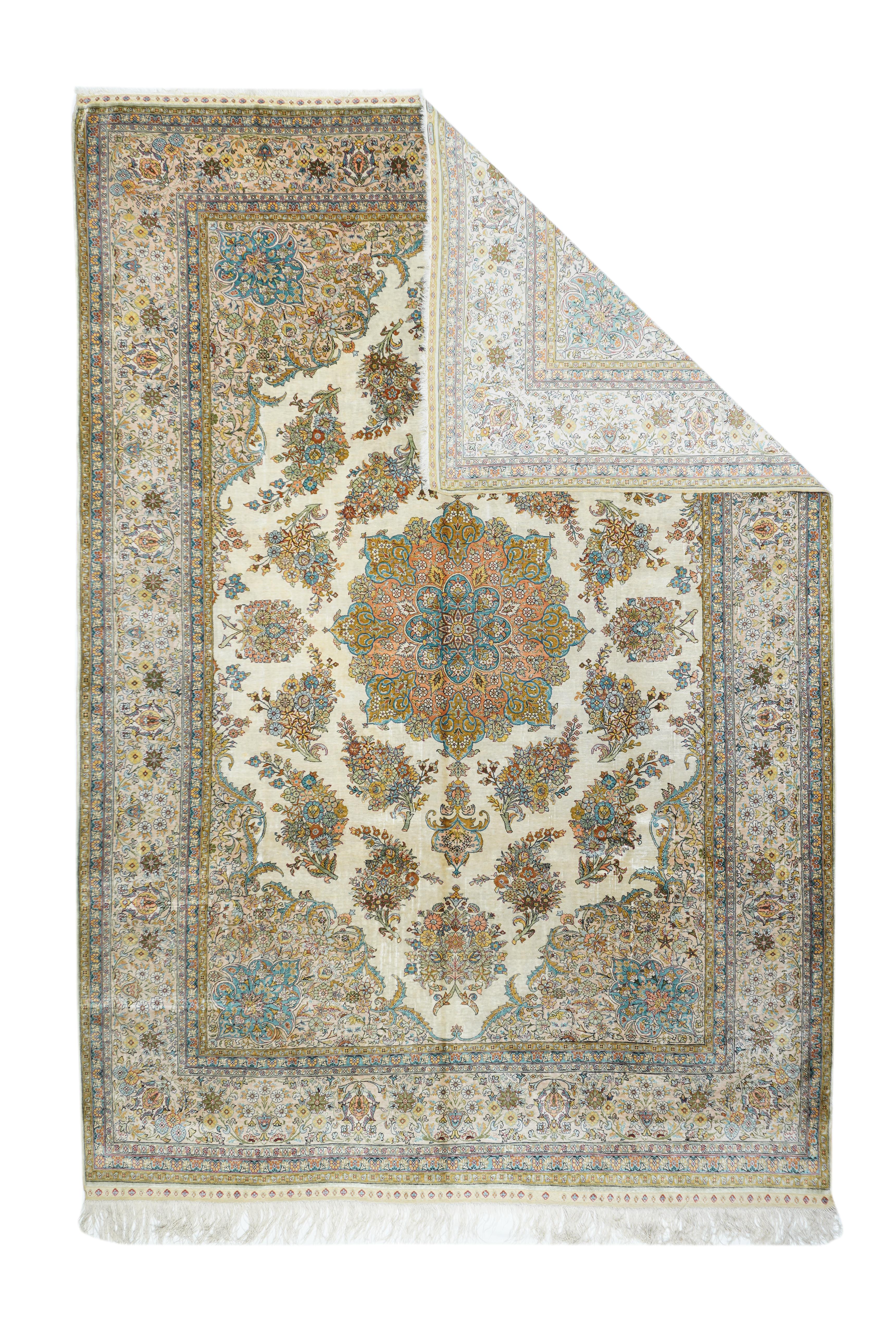 This very finely knotted Turkish city carpet from the Istanbul suburbs is completely Persian in style from the creamy ivory field with a round, 16 point and lobe medallion surrounded by two broken wreaths of intensely floriated botehs. Surging