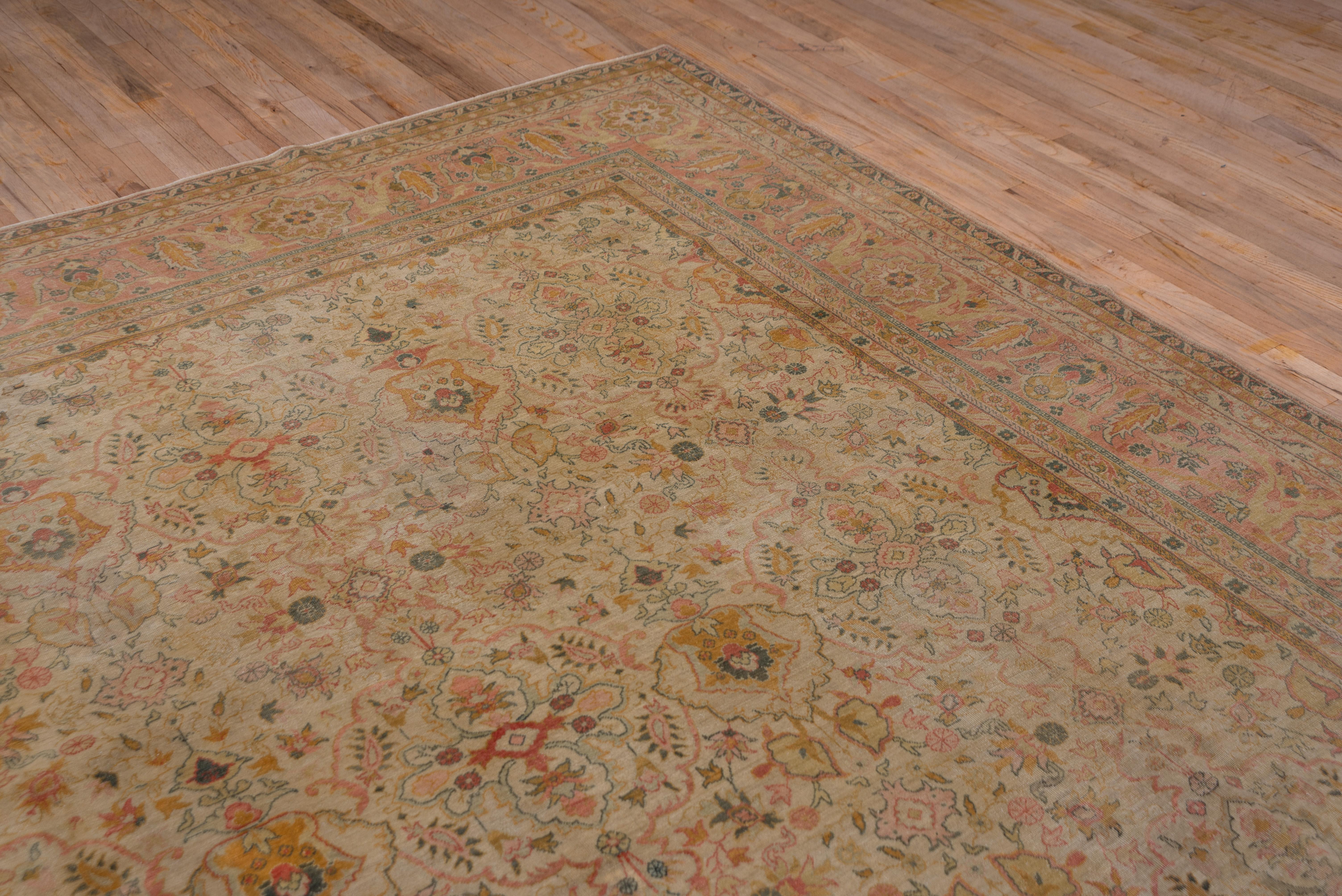 The old ivory field of this eastern Turkish city carpet of moderate weave and cotton foundation, shows an allover pattern of palmettes, flower and palmette open cruciforms, short and broken stems and numerous other closely set floral forms. Straw