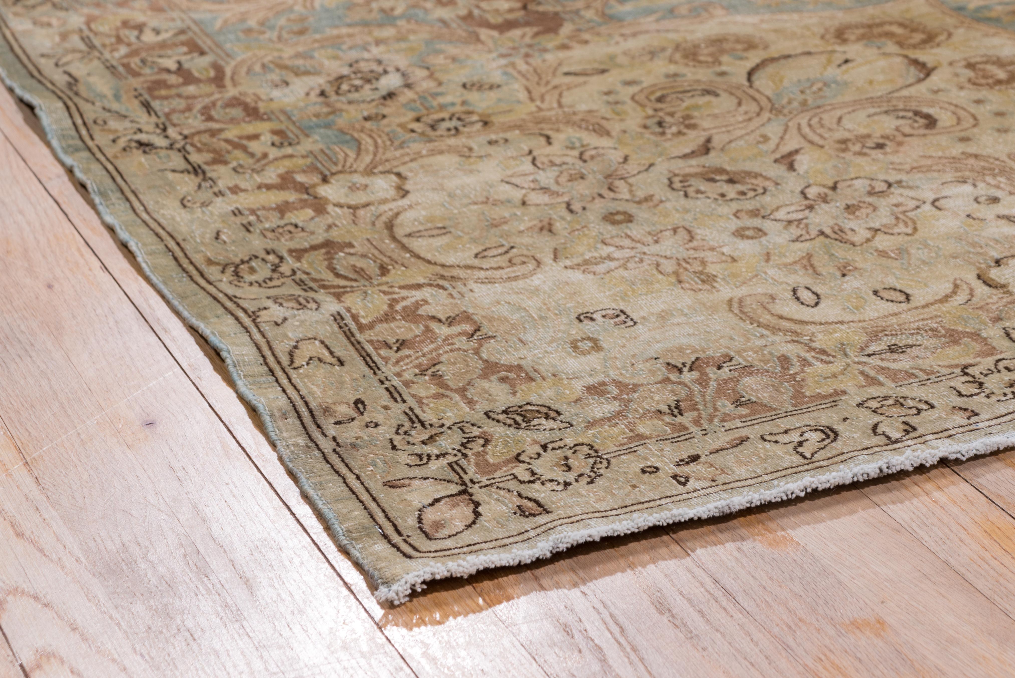 This elegant eastern Turkish urban carpet shows a light blue open field embracing a slightly scalloped and pendanted medallion with surrounding semi-circular garlands, all within a Kerman-style partially broken light blue acanthus and floral border.