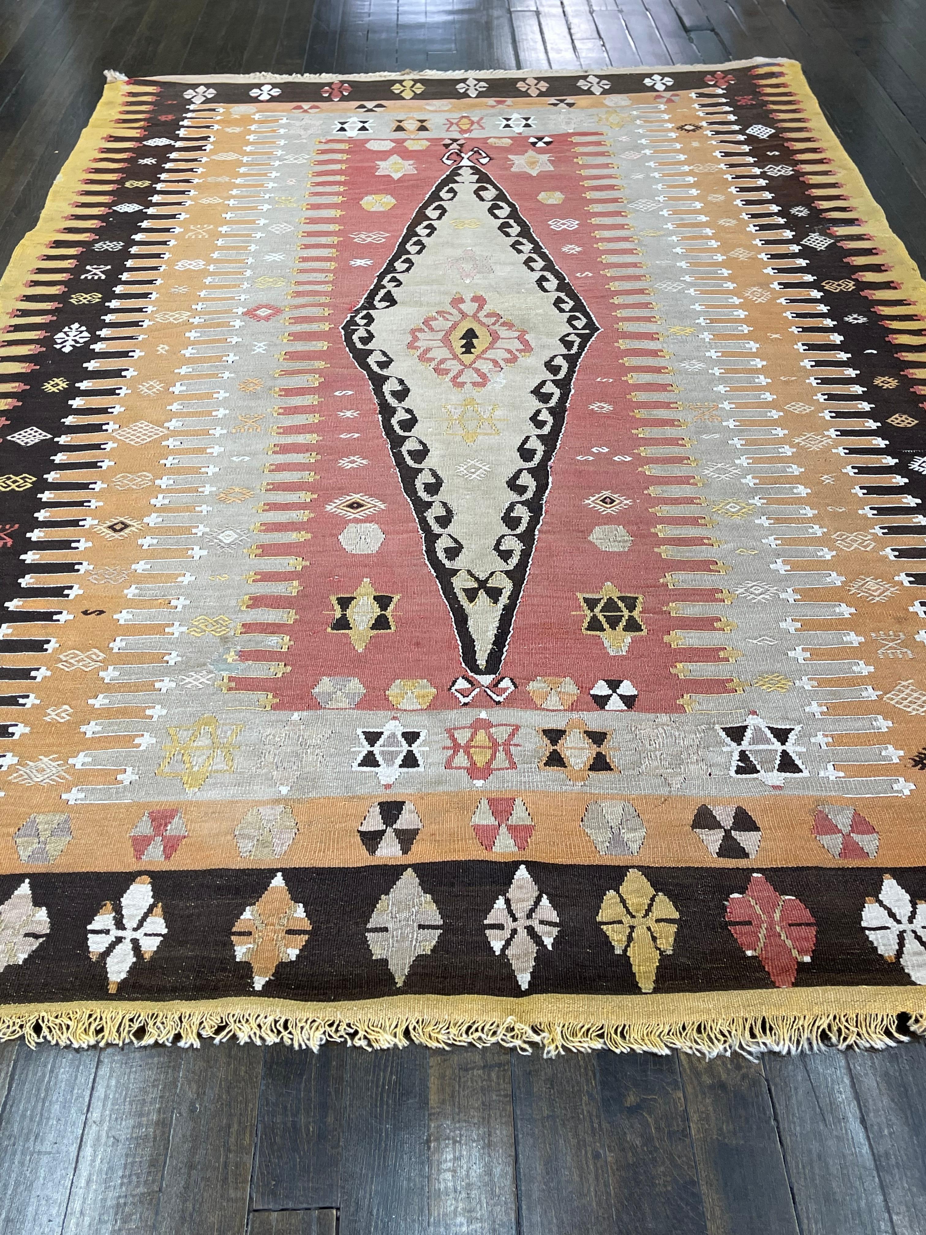 This flat-woven Klim is handmade in Sivas region of Turkey.Flat-woven rugs are hand-loomed textiles with flat surface-without pile-which present a relatively two dimensional surface.Their basic structure is a plain weave which results when warp and