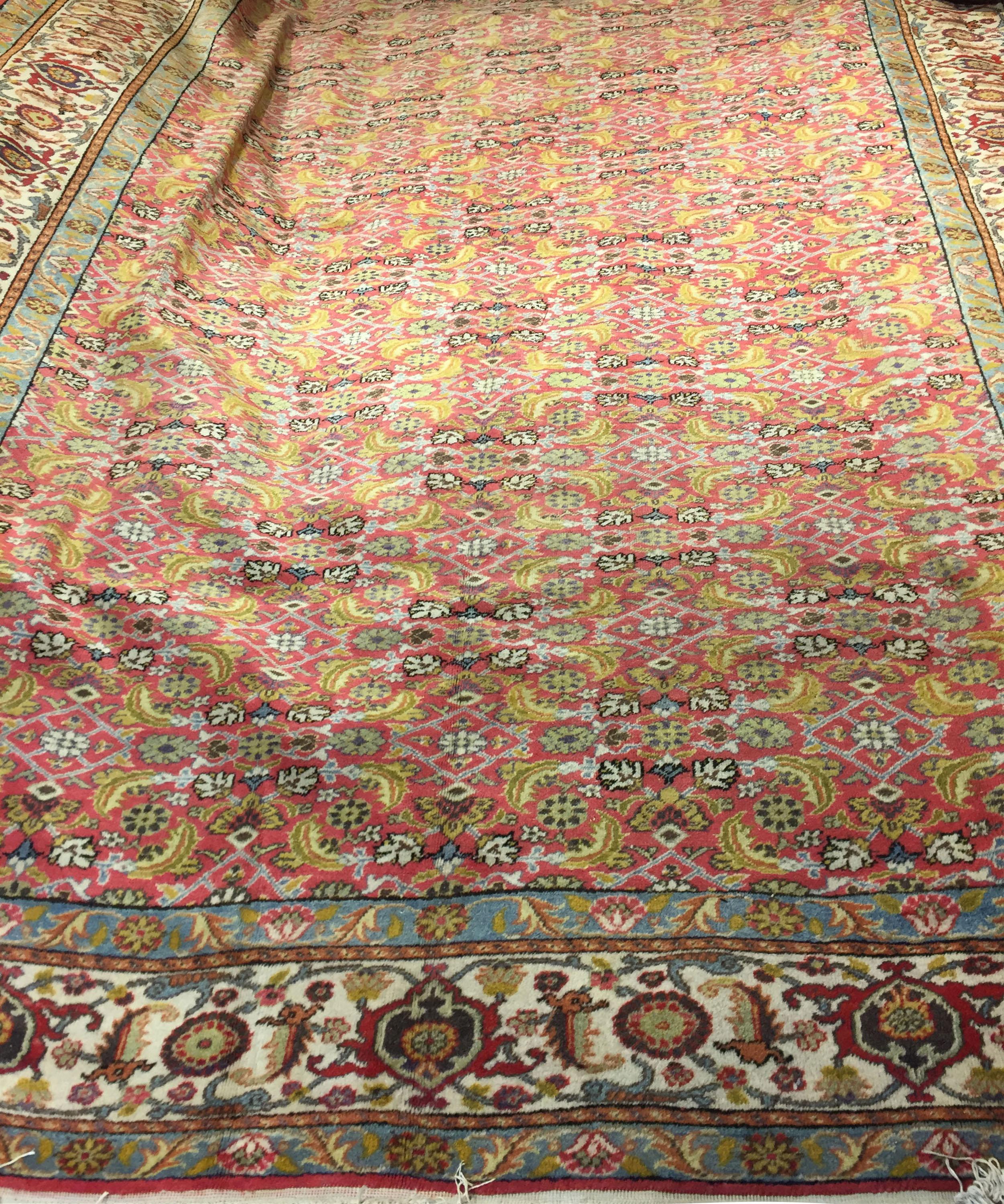 Antique Turkish Sivas rug. A wonderful Turkish Sivas handwoven rug with all the attributes that one looks for in a room size rug. The perfect central filed filled with floral designs coupled with the main border in an ivory color and repeating the
