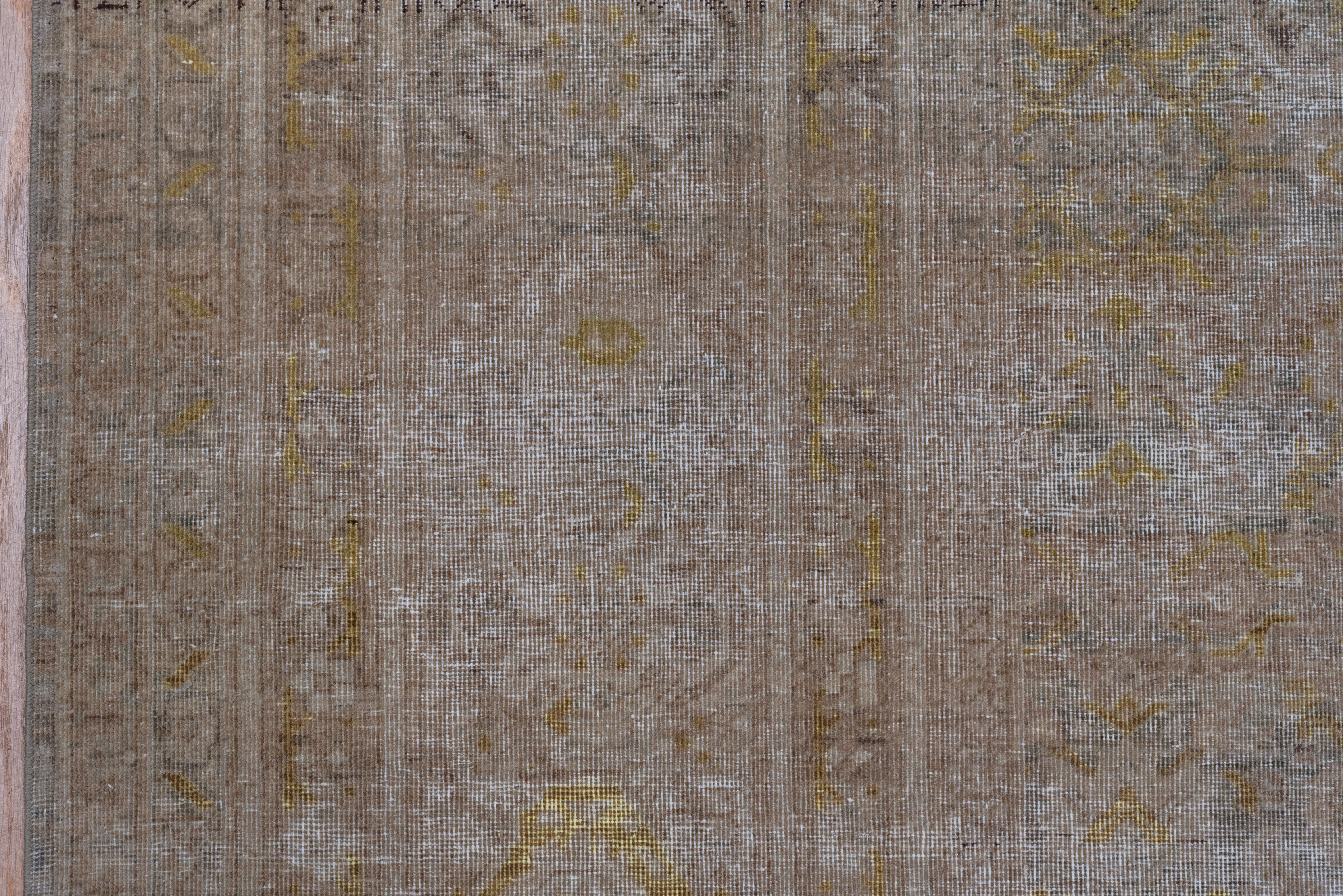 The very light brown taupe field shows an all-over Herati pattern in the Persian Tabriz manner. The main border shows reversing turtle palmettes with yellow detailing. A few partial lines of darker abrash. Fair condition. Gold, electric yellow