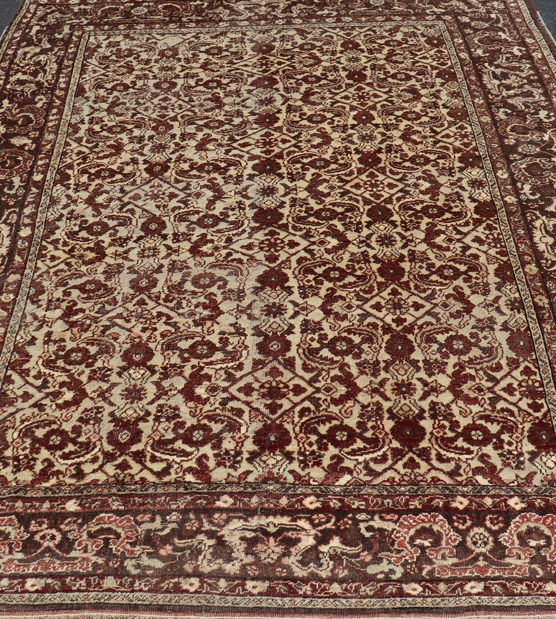 Wool Antique Turkish Sivas Rug with Tan Background and Maroon, Eggplant, Brown Color  For Sale