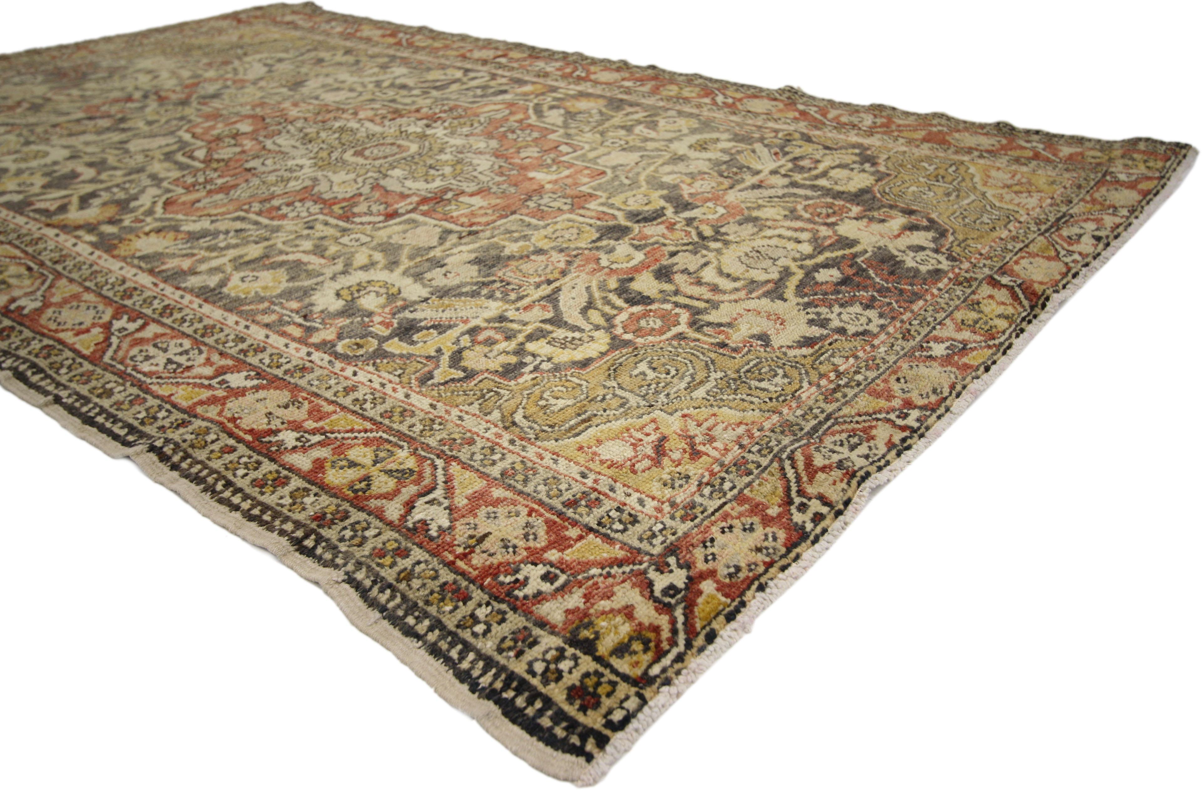 50245 Antique Turkish Sivas Rug, 04'03 x 06'06. 
With warm spice-tones and lovingly rustic appearance, this hand knotted wool antique Turkish Sivas rug embraces English Manor style. It features an intricate central medallion surrounded by an
